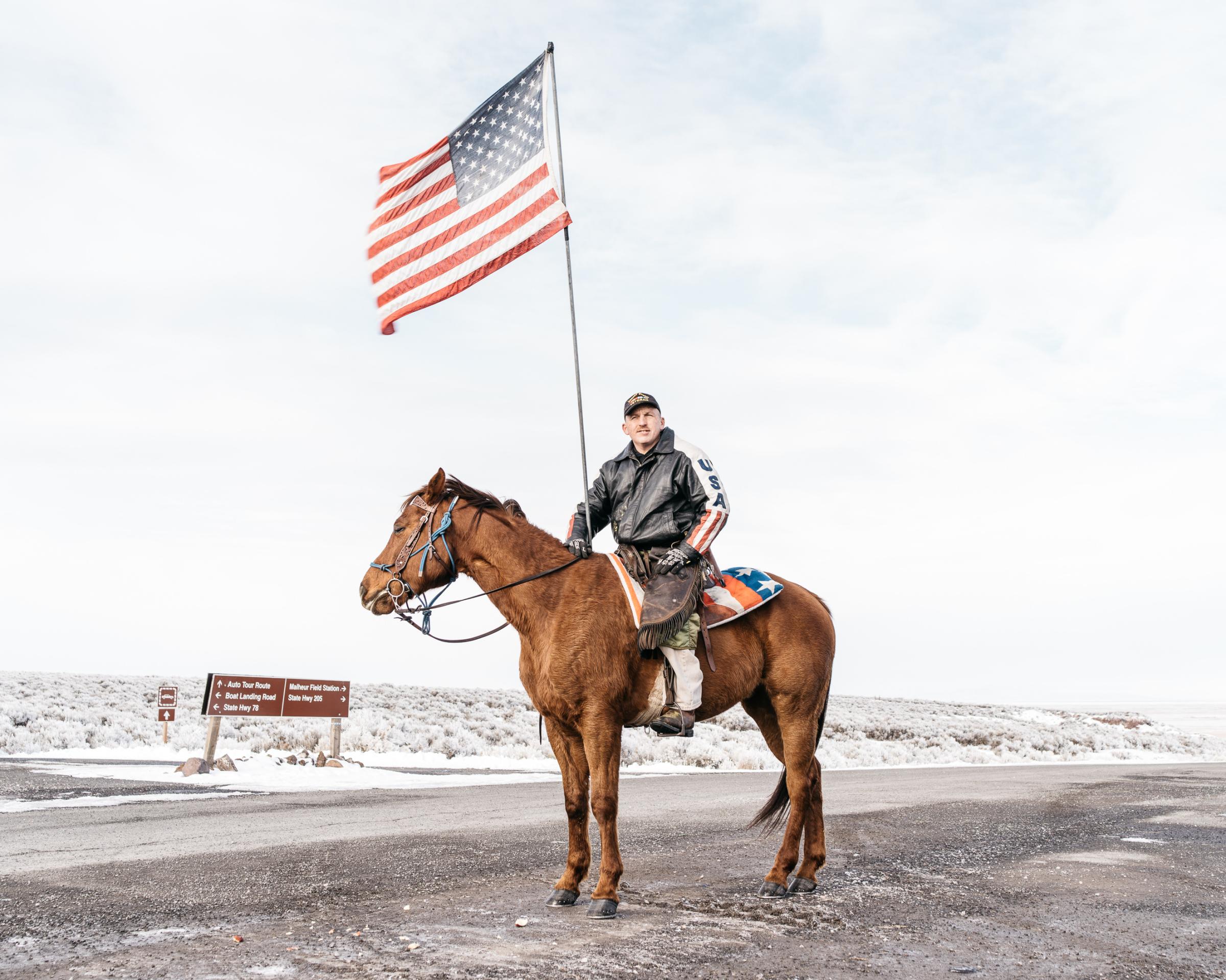 Dwayne Ehmer, of Irrigon, Ore., sits atop his horse Hellboy as they greet media on Jan. 12, 2016, at the entrance to the Malheur National Wildlife Refuge in Harney County, Ore.