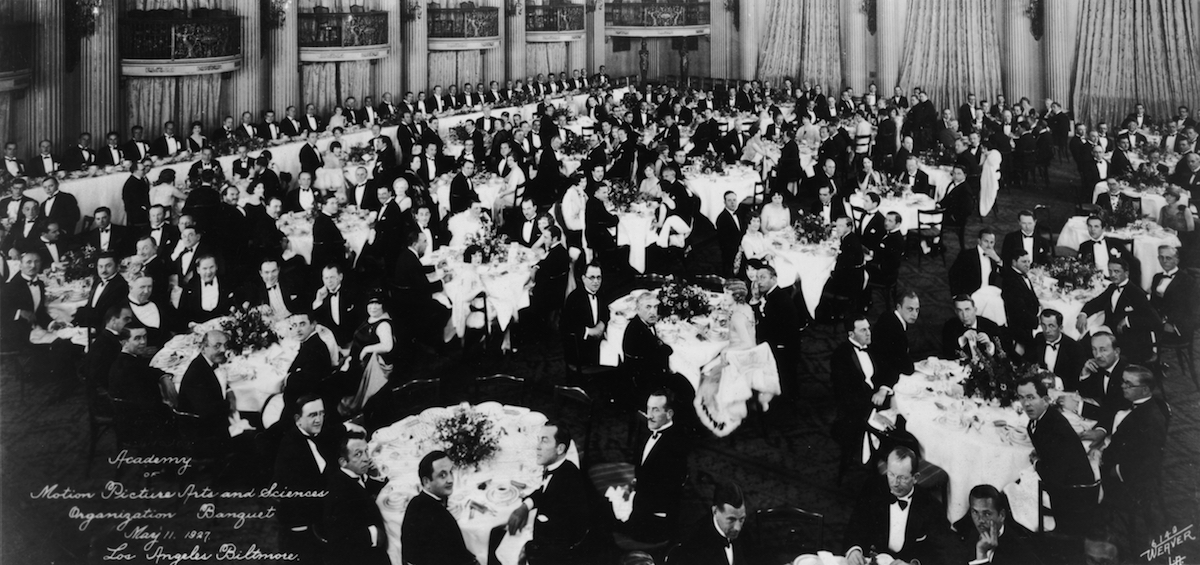 Interior view of formally dressed men and women seated at tables during the May 11, 1927, first organizational meeting of the Academy of Motion Picture Arts and Sciences in the Crystal Ballroom of the Los Angeles Biltmore Hotel. (Hulton Archive / Getty Images)