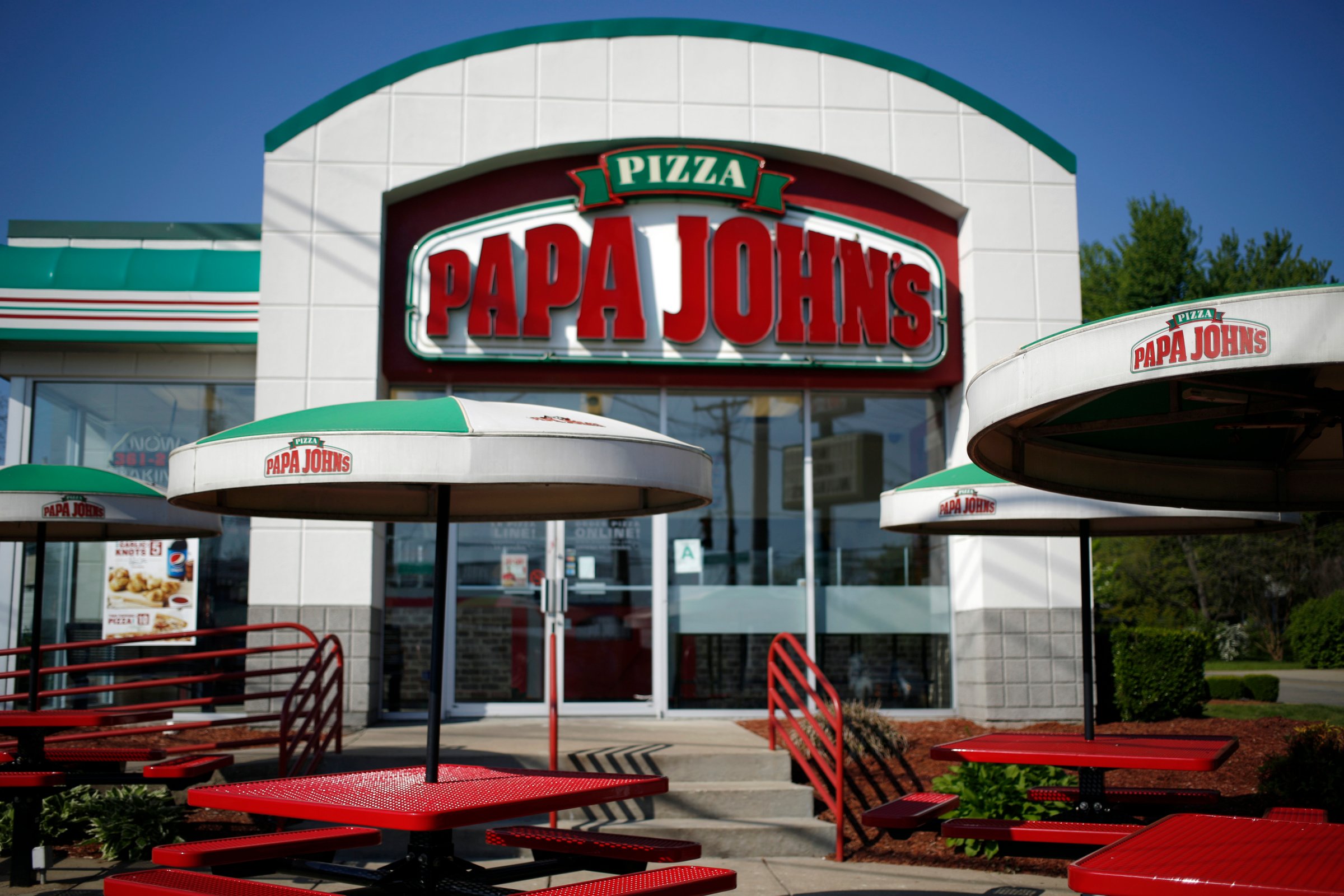 Umbrellas and outdoor seating stand outside a Papa John's International Inc. restaurant in Louisville, Kentucky, U.S., on Friday, May 1, 2015.
