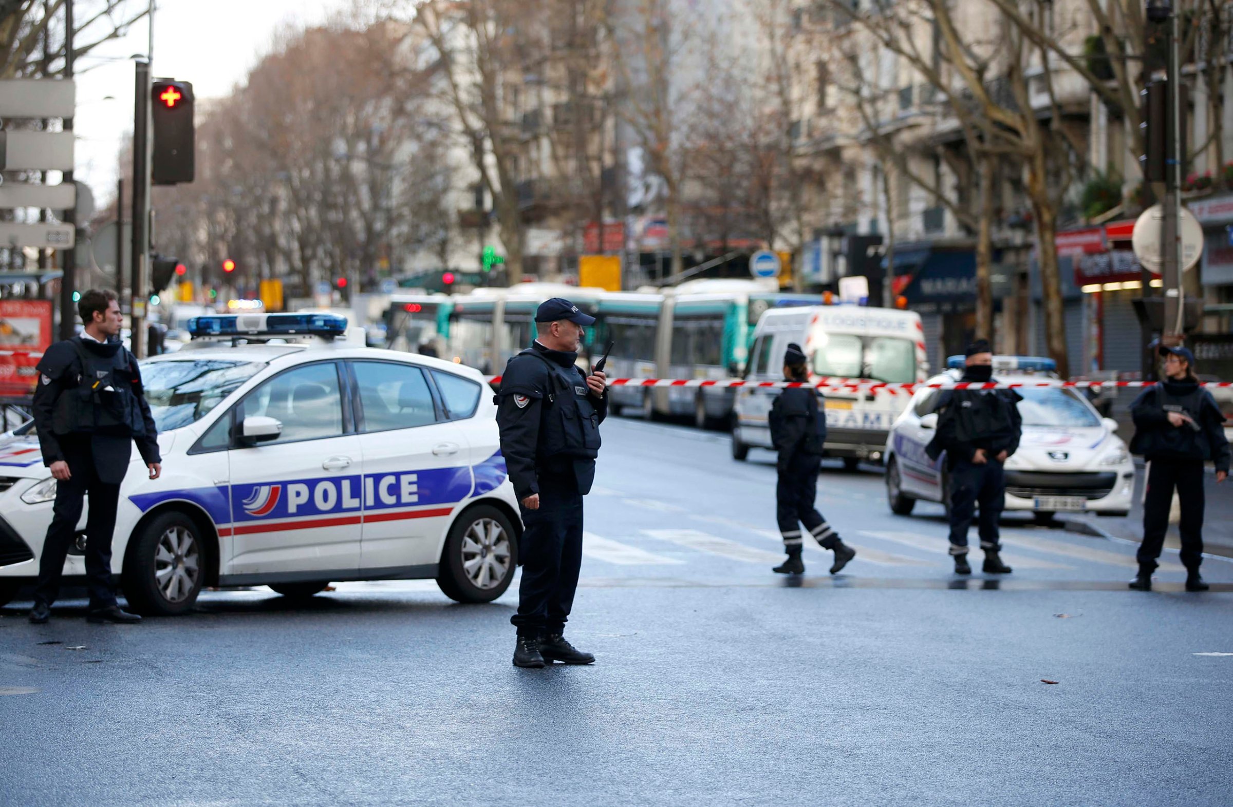 French police secure the area after a knife-wielding man was shot dead after attempting to enter a police station in the 18th district in Paris, Jan. 7, 2016.