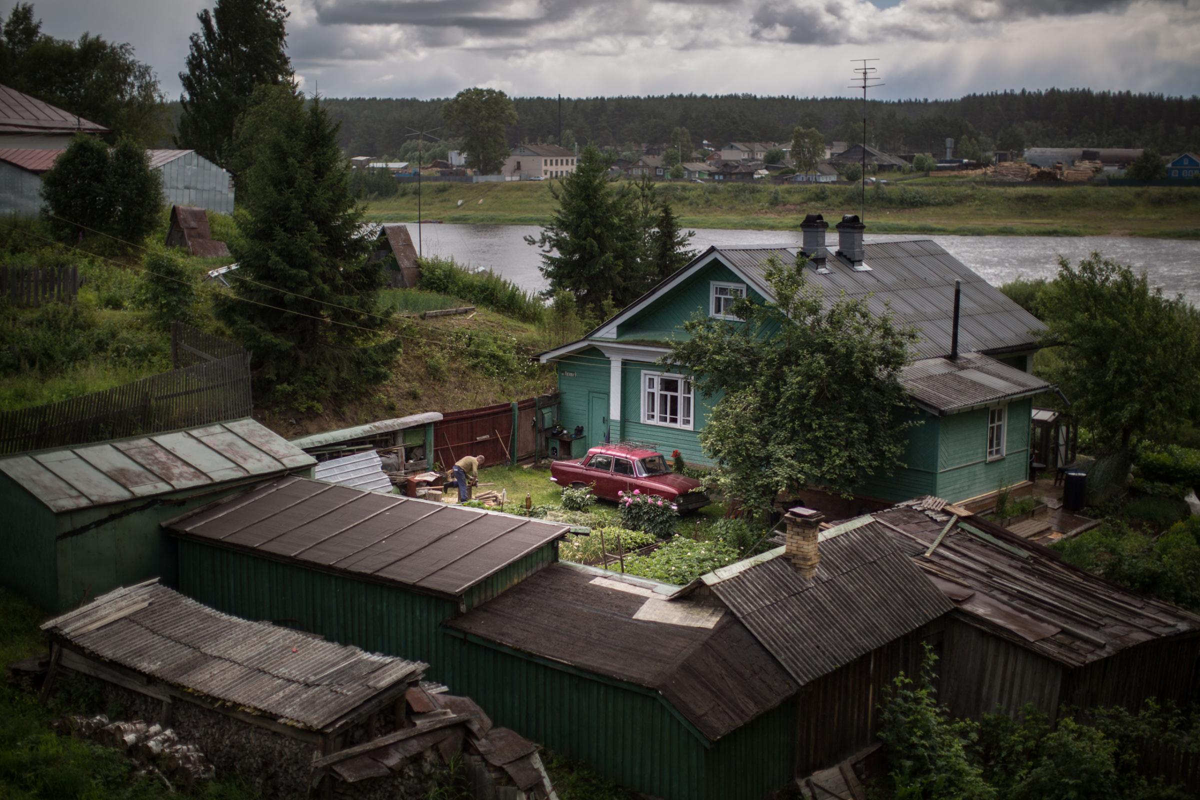 A local man works in a garden of his private house on the bank of Sukhona River in the town of Totma, the administrative center of Totemsky District in Vologda Oblast, Russia.