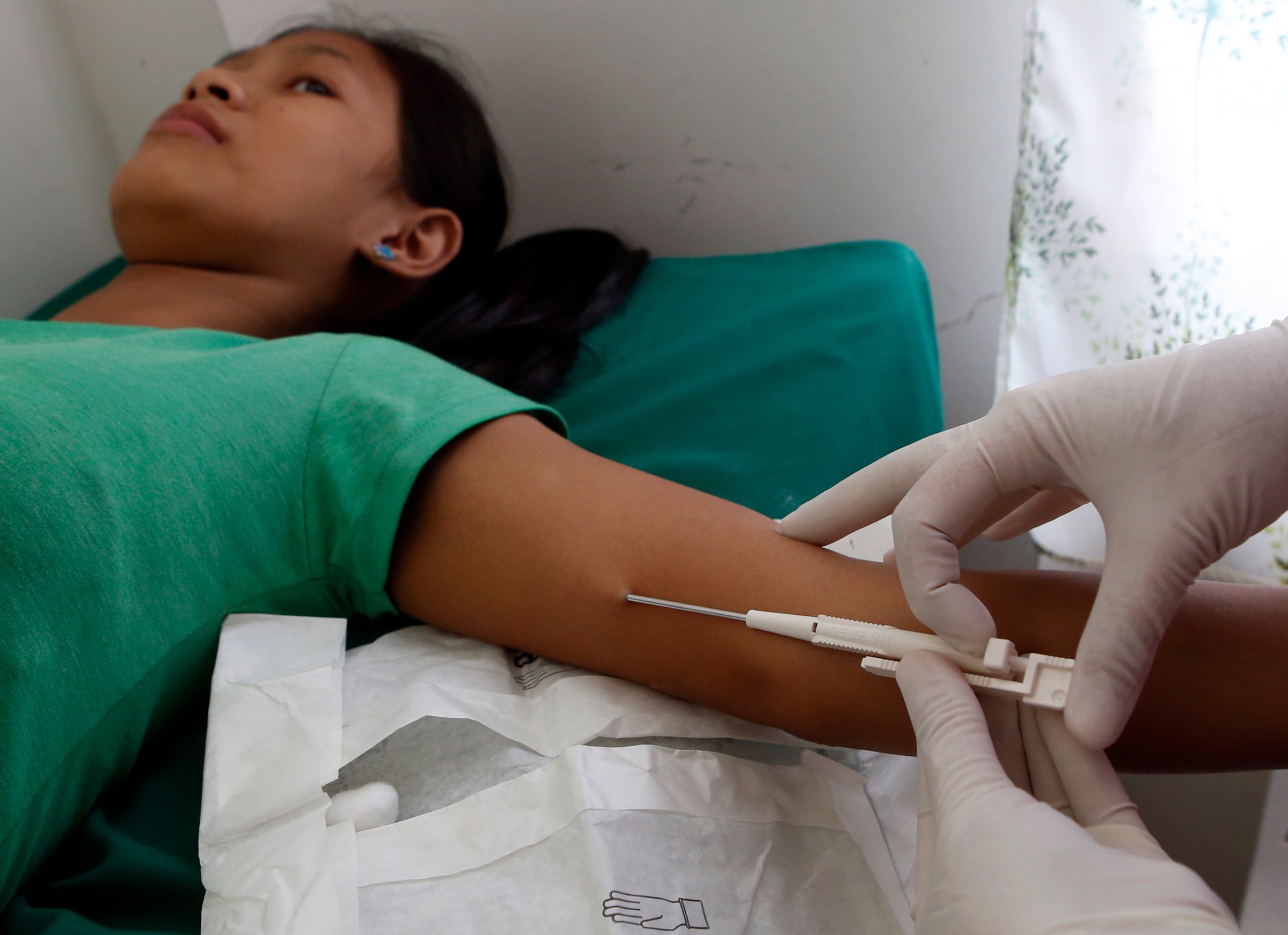 A 16-year-old mother receives a free contraceptive implant during a reproductive health medical mission organized by the United Nations Population Fund (UNFPA) in Tondo, Manila