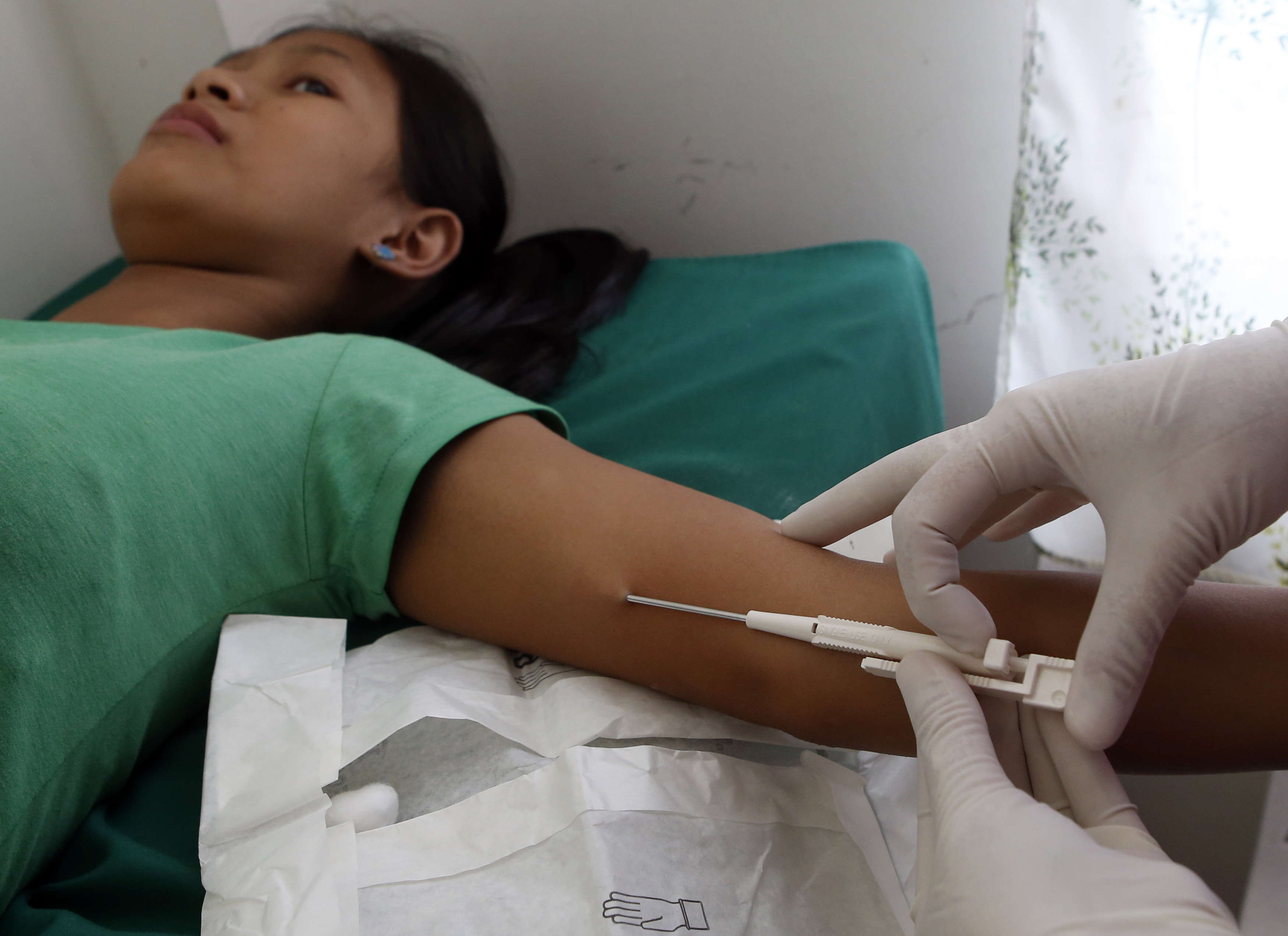 A 16-year-old mother receives a free contraceptive implant during a reproductive health medical mission organized by the United Nations Population Fund (UNFPA) in Tondo, Manila