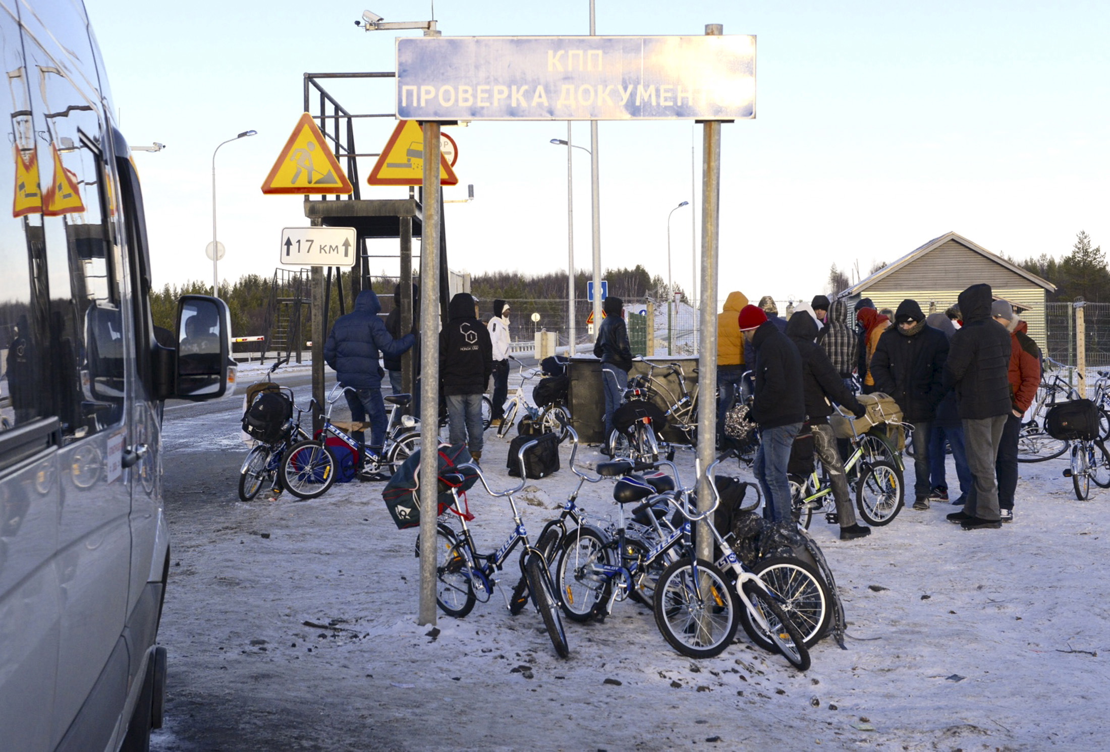 Refugees and migrants gather near a check point on the Russian-Norwegian border outside Nickel (Nikel) settlement in Murmansk region, Russia, on Oct. 30, 2015 (Stringer—Reuters)