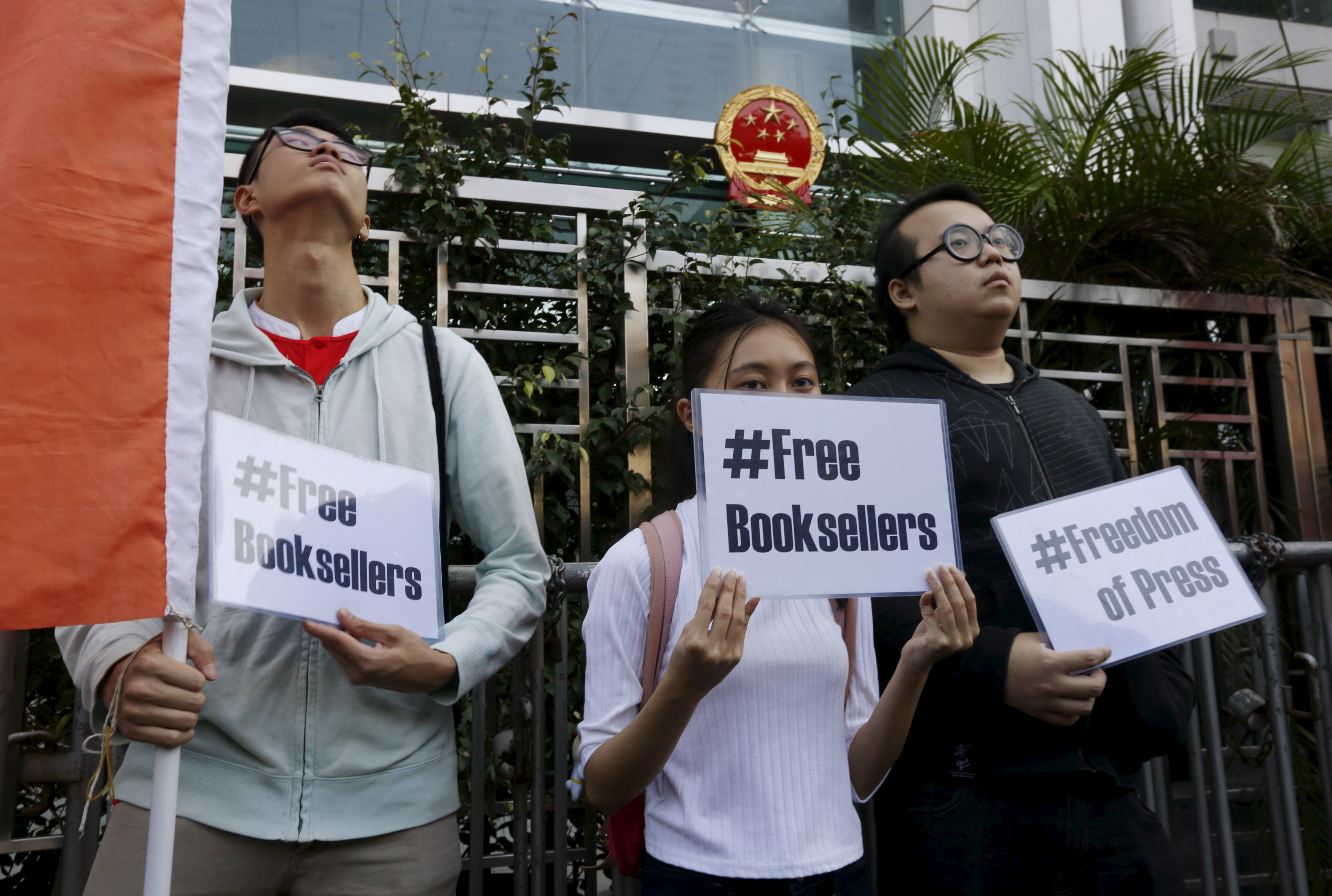Members of student group Scholarism hold up placards during a protest about the disappearances of booksellers outside China's liaison office in Hong Kong, China