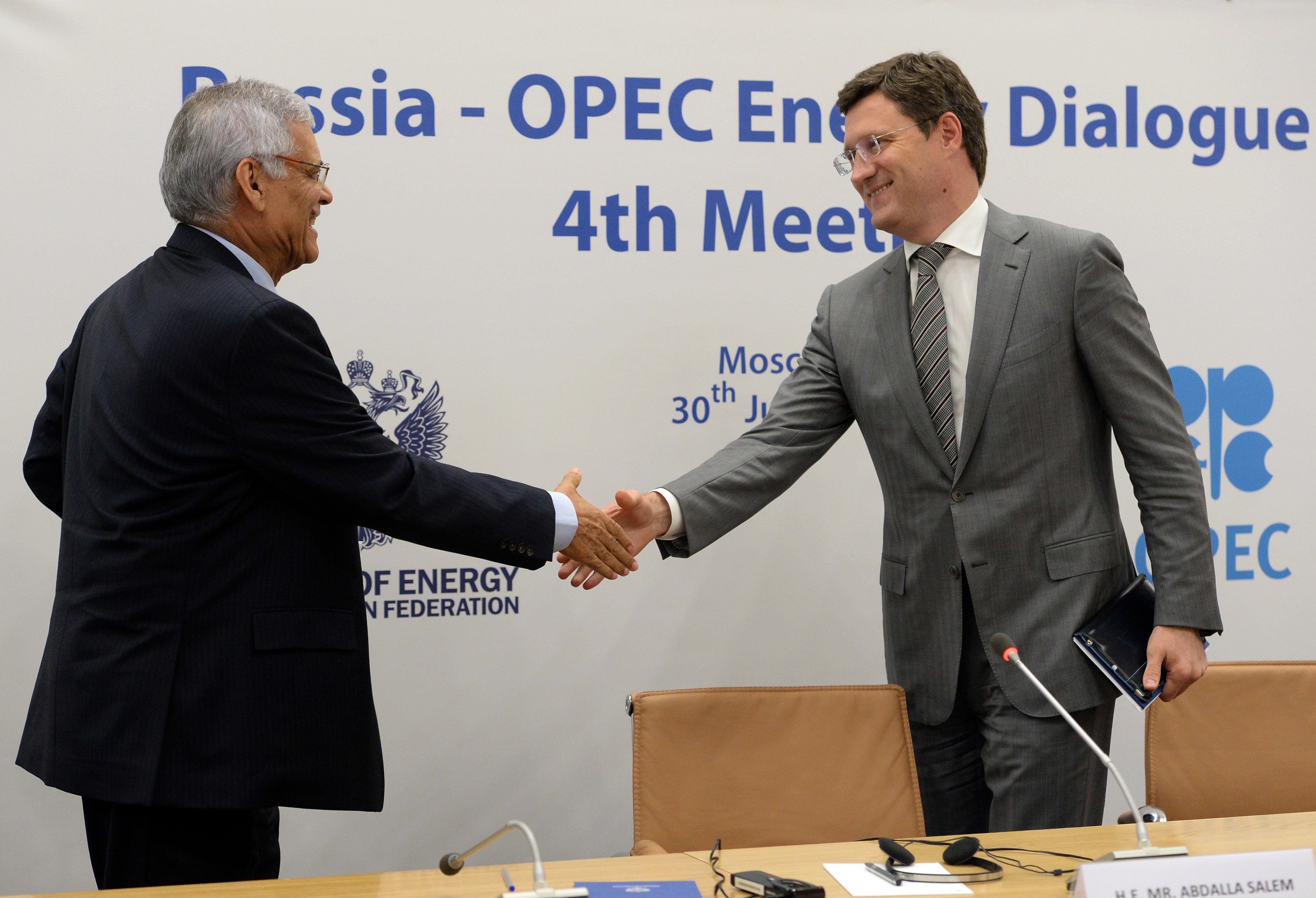OPEC Secretary-General Abdalla Salem El-Badri and Russia's Energy Minister Alexander Novak shake hands during a press-conference after Russia-OPEC energy dialogue meeting in Moscow on July 30, 2015. (Vasily Maximov—AFP/Getty Images)