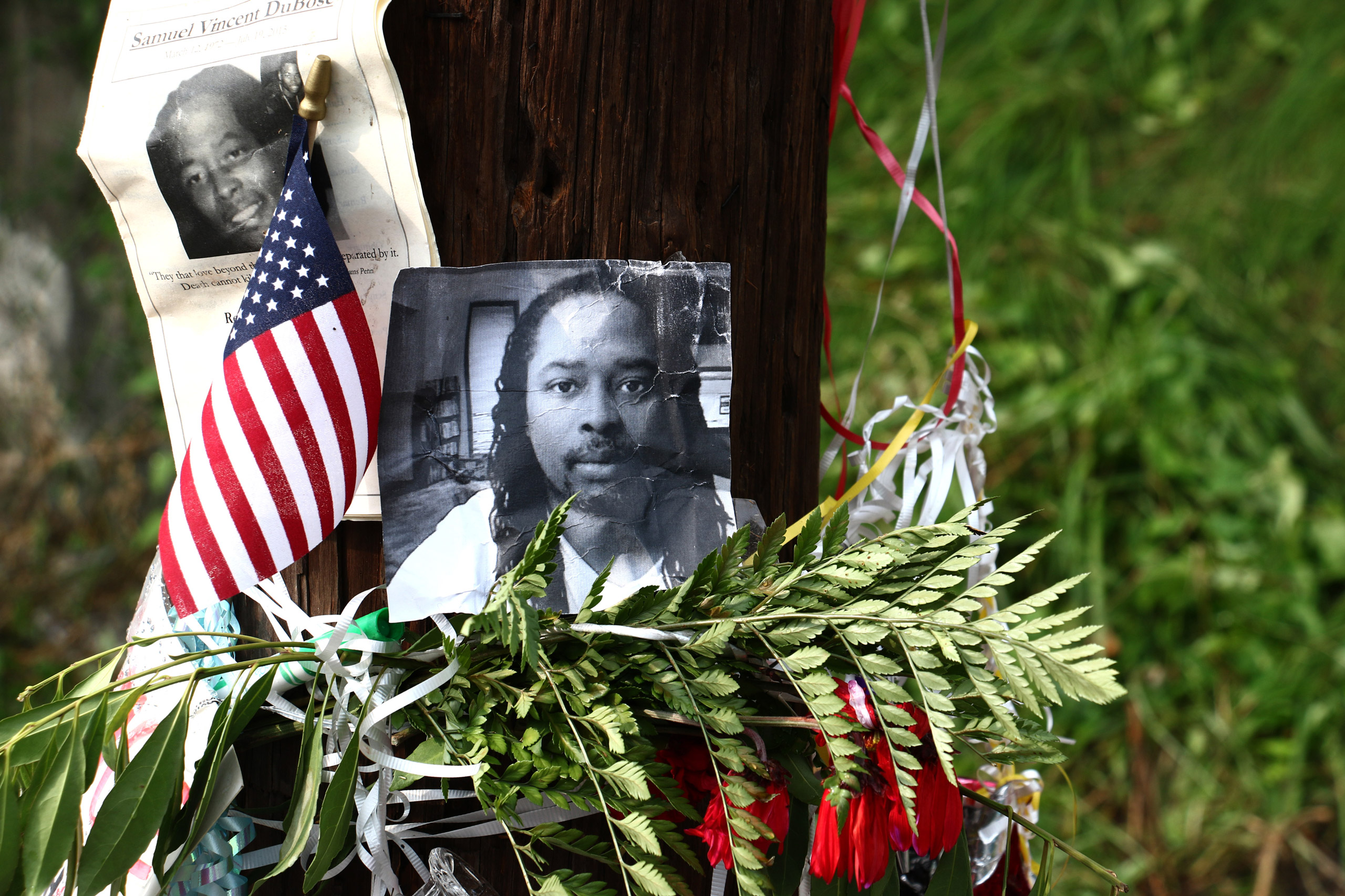 Photos of Samuel DuBose hang on a pole at a memorial  in Cincinnati on July 29, 2015. (Tom Uhlman—AP)