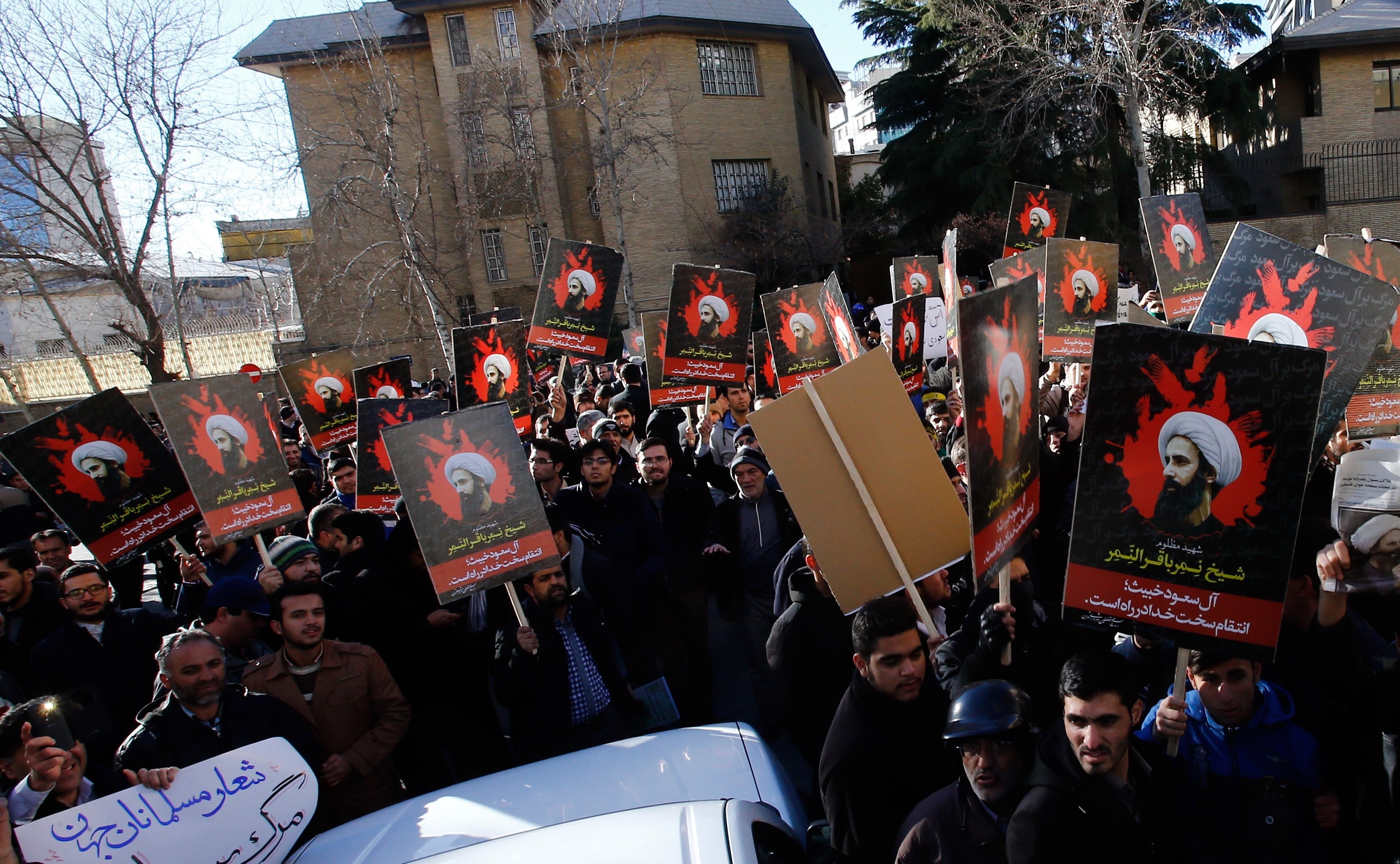 Demonstrators hold posters of Nimr Baqir al-Nimr and shout slogans during a protest rally outside the embassy of Saudi Arabia against the execution of prominent Saudi Shia cleric Nimr Baqir al-Nimr by Saudi authorities, in Tehran, Iran on Jan. 3 2016. (Anadolu Agency—Getty Images)