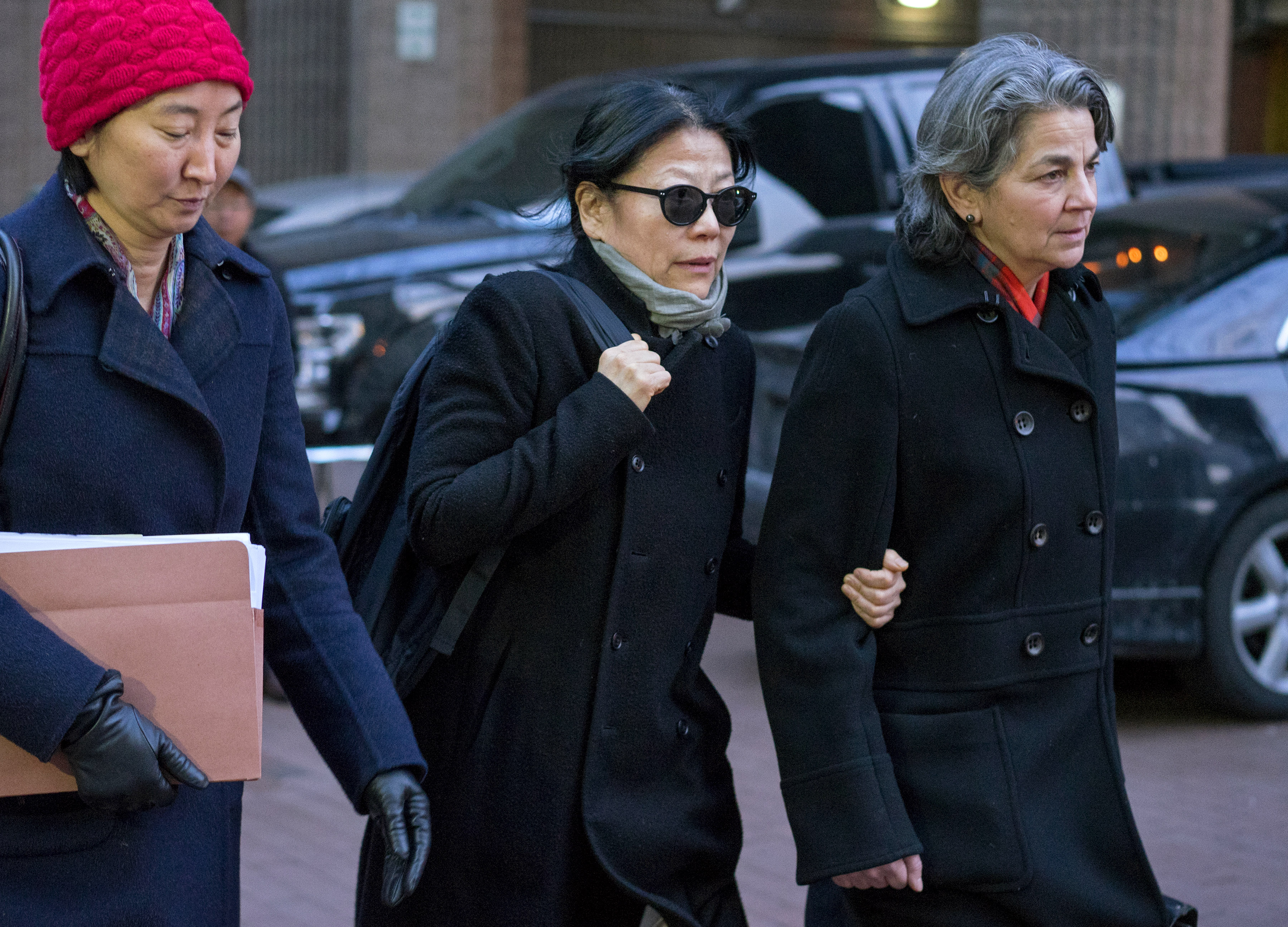 Shiwei Yan, CEO of Global Sustainability Foundation, center, leaves federal court in New York after she plead guilty in connection with a scheme to bribe ex-UN General Assembly President John Ashe on Jan. 20, 2016. (Craig Ruttle—AP)