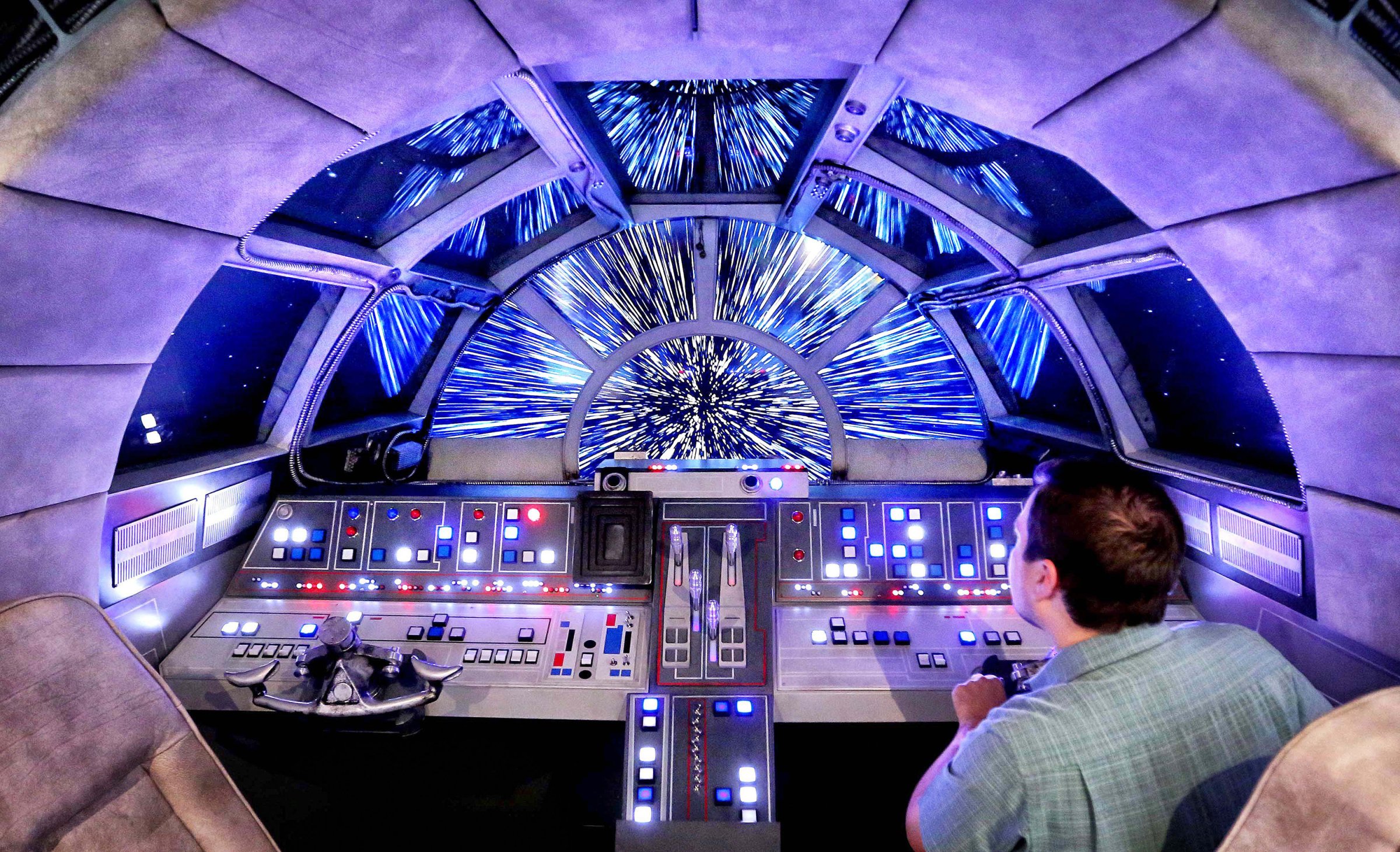 Danny Handke, a creative design executive with Walt Disney Imagineering, demonstrates the hyper reality of the cockpit in the new Star Wars Millennium Falcon play area onboard the Disney Dream, as Disney Cruise Lines unveils the enhancements to the ship on Oct. 30, 2015.
