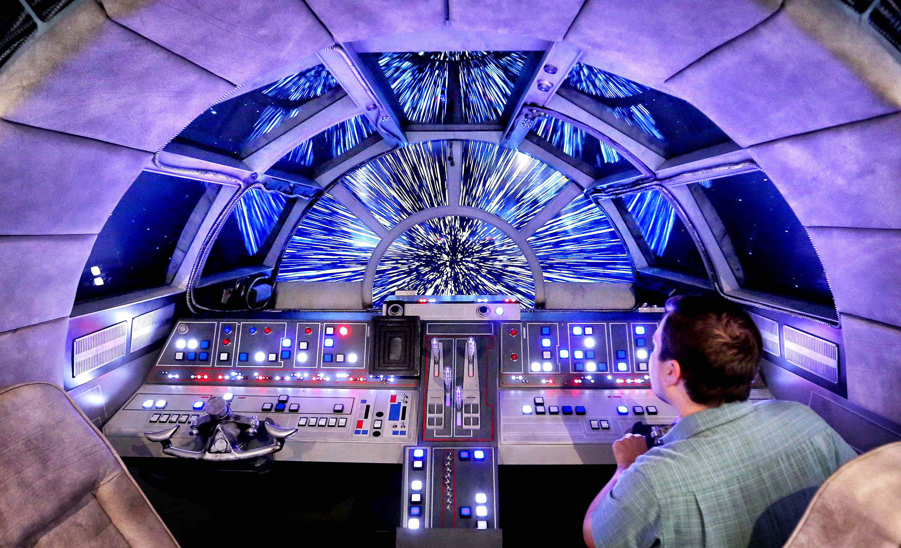 Danny Handke, a creative design executive with Walt Disney Imagineering, demonstrates the hyper reality of the cockpit in the new Star Wars Millennium Falcon play area onboard the Disney Dream, as Disney Cruise Lines unveils the enhancements to the ship on Oct. 30, 2015. (Joe Burbank—Orlando Sentinel/TNS/Getty Images)