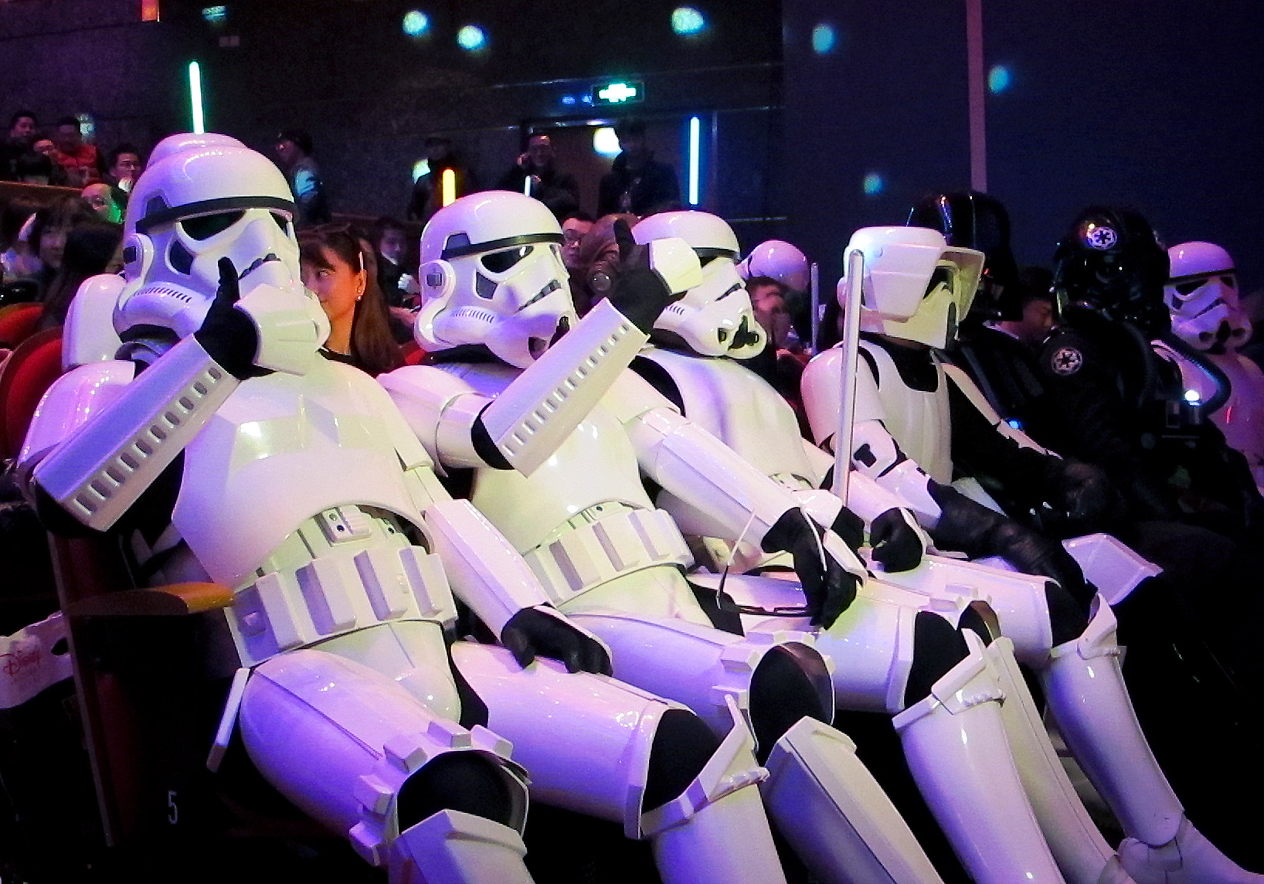 Chinese fans, dressed as Star Wars character Stormtroopers, gesture as they arrive for the premiere of 