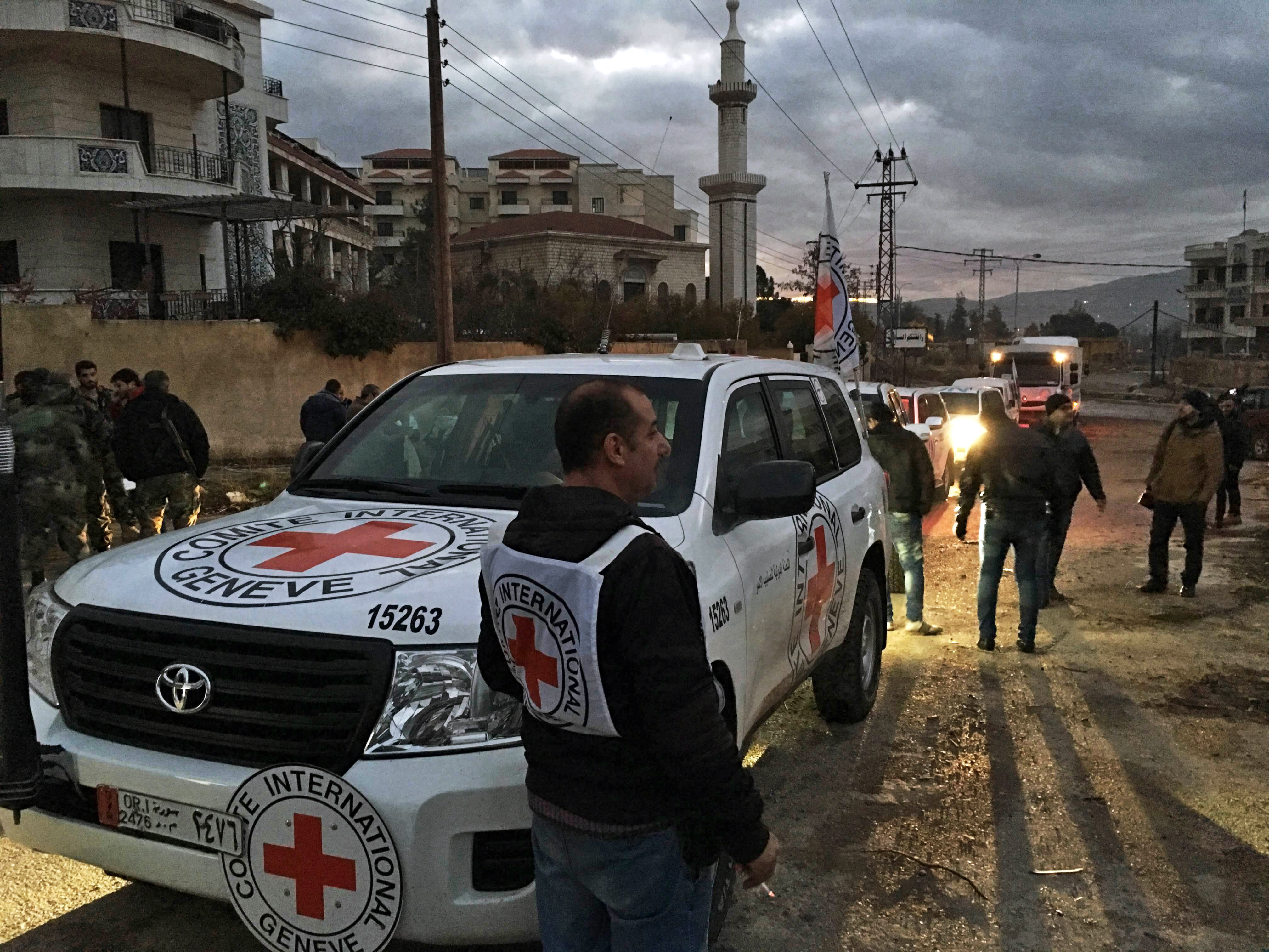 This Jan. 11, 2016 photo released by the International Committee of the Red Cross shows a Red Cross aid convoy upon its arrival at the besieged city of Madaya, Syria. (International Committee of the Red Cross/EPA)