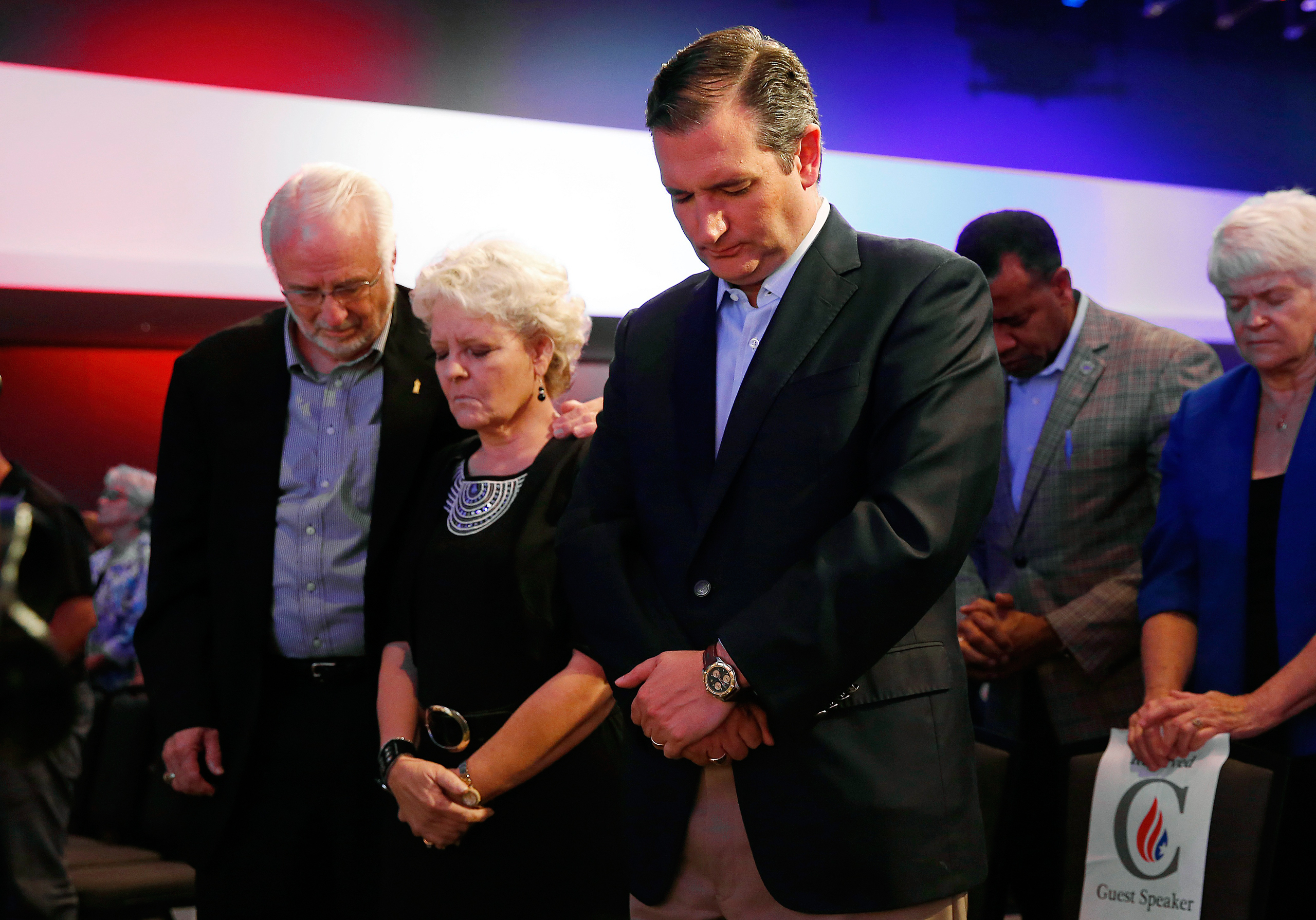 Cruz prays with Iowans Dick and Betty Odgaard, left, at a rally for religious liberty in Des Moines in August (Paul Sancya—AP)