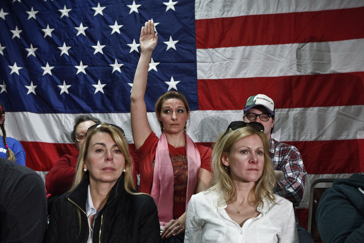 A woman raises her hand during a Town Hall meeting with New Jersey Gov. Chris Christie on Feb. 19, 2014 in Middletown, N.J. (Kena Betancur—Getty Images)