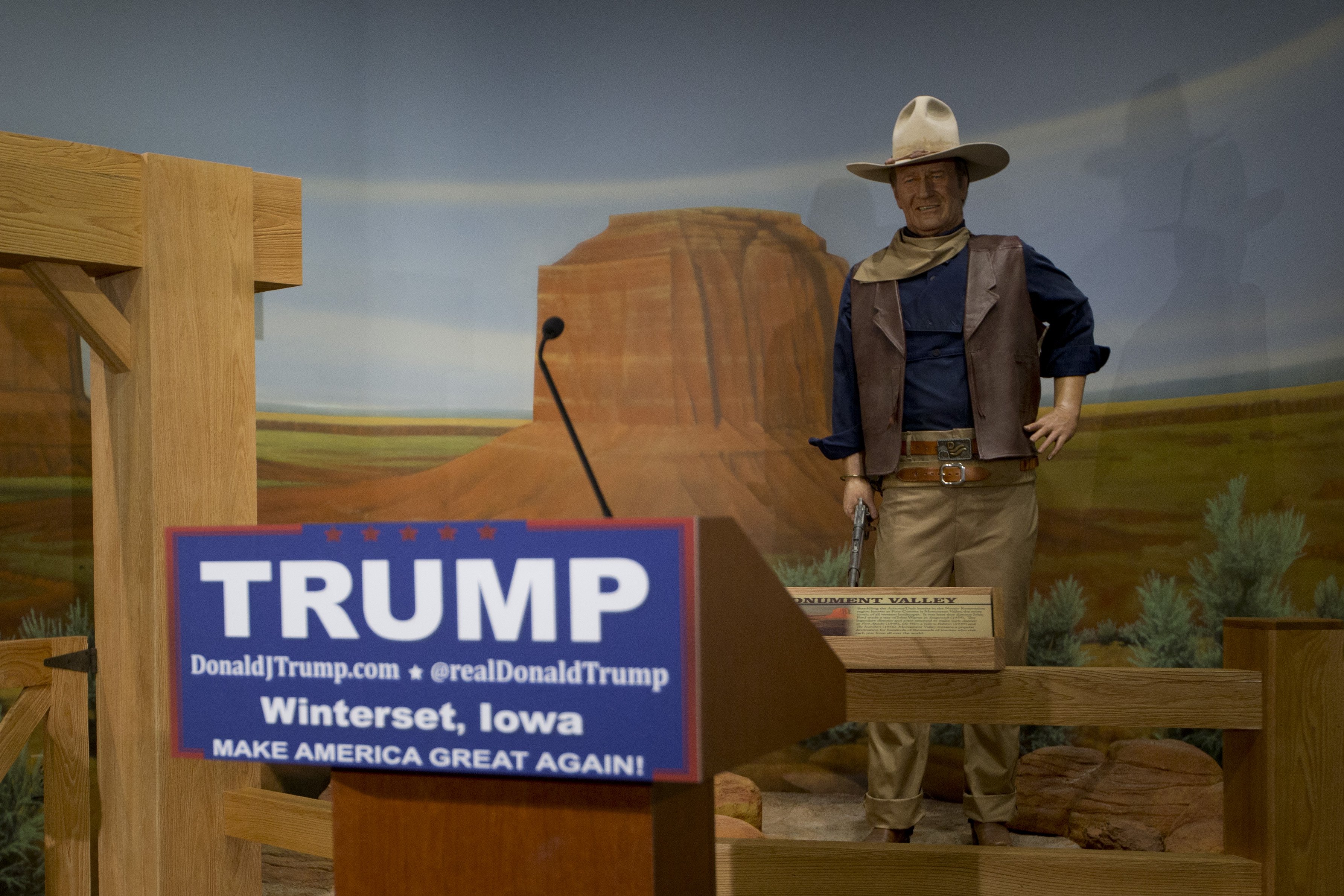 A podium for Donald Trump stands in front of a wax statue of John Wayne at the John Wayne Museum on Jan. 19, 2016, in Winterset, Iowa. (Jae C. Hong—AP)
