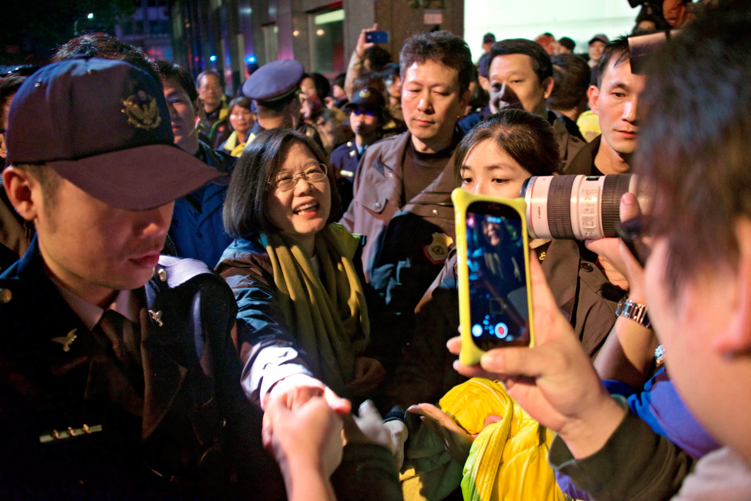 Tsai Ing-wen greets members of the public on January 16, 2016, as she leaves the DPP headquarters celebrations in Taipei, Taiwan.