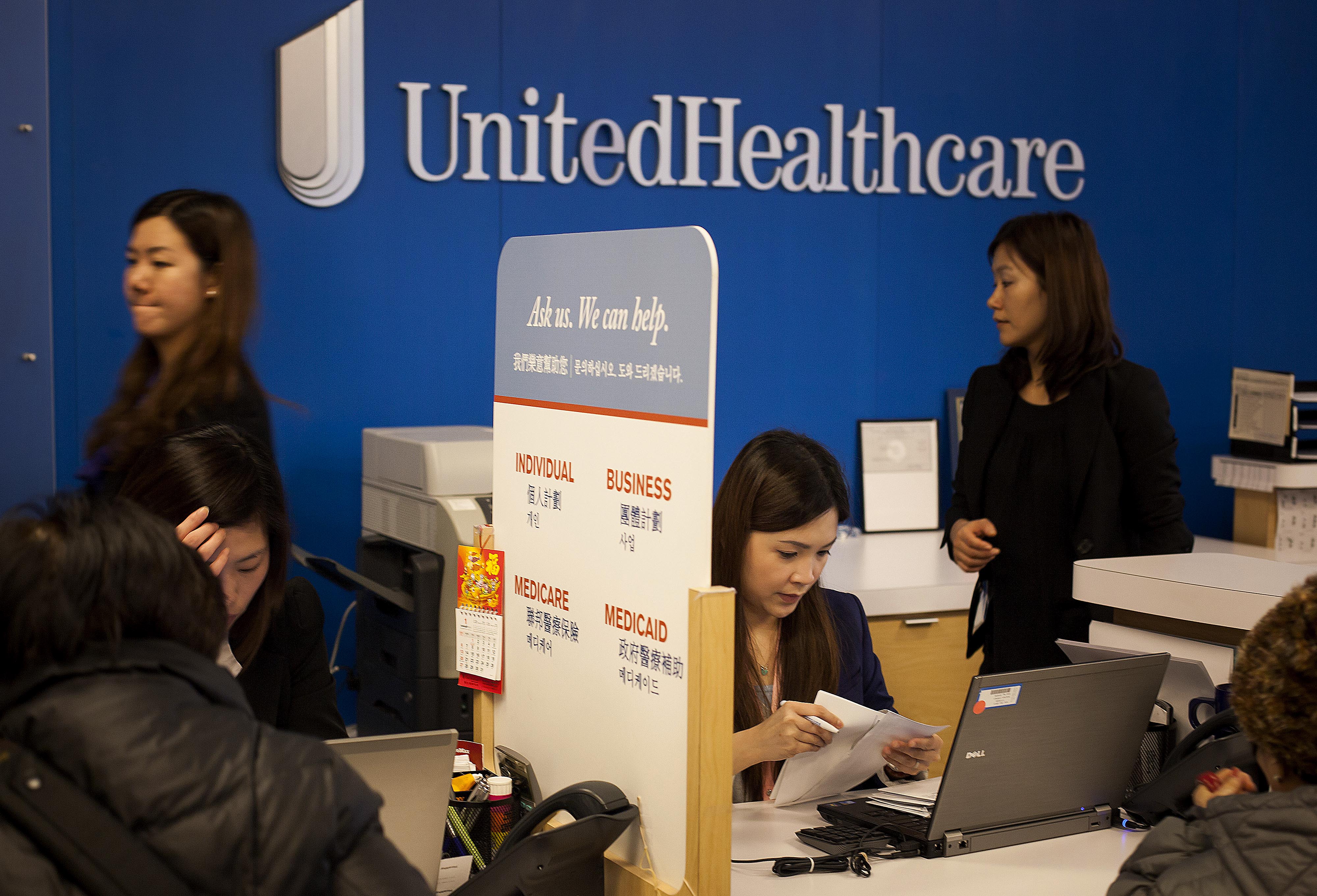Representatives speak with customers at a UnitedHealthcare store in the Queens borough of New York, U.S., on Monday, Jan. 14, 2013. (Michael Nagle—Bloomberg/Getty Images)