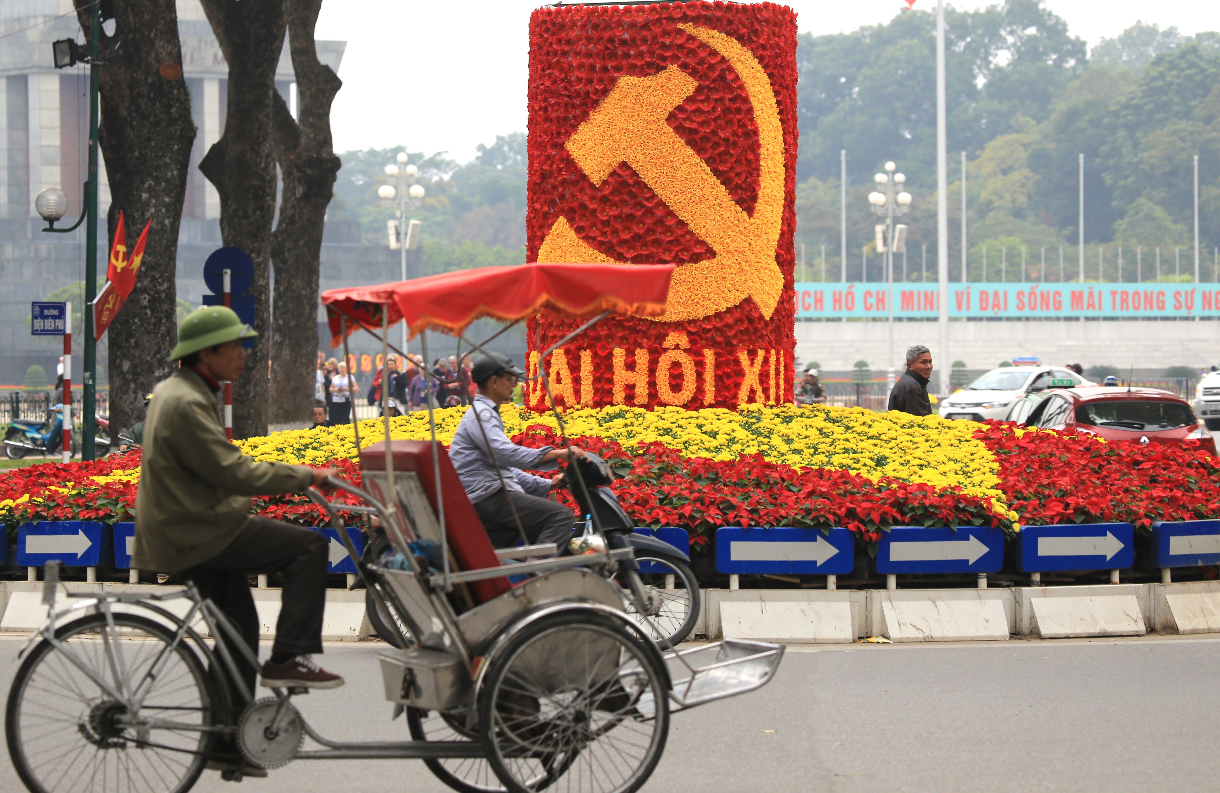 Vehicles drive past a sign marking the 12th Congress of the Communist Party of Vietnam in Hanoi on Jan. 19, 2016. This week, some 1,510 representatives of the Communist Party gather in the capital to pick the country's new leaders (Hau Dinh—AP)
