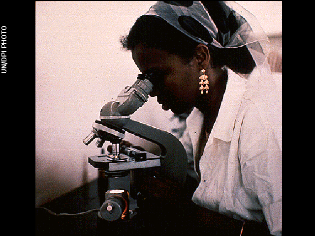 A student uses a microscope in a Mogadishu, Somalia health center in Jan. 1970.