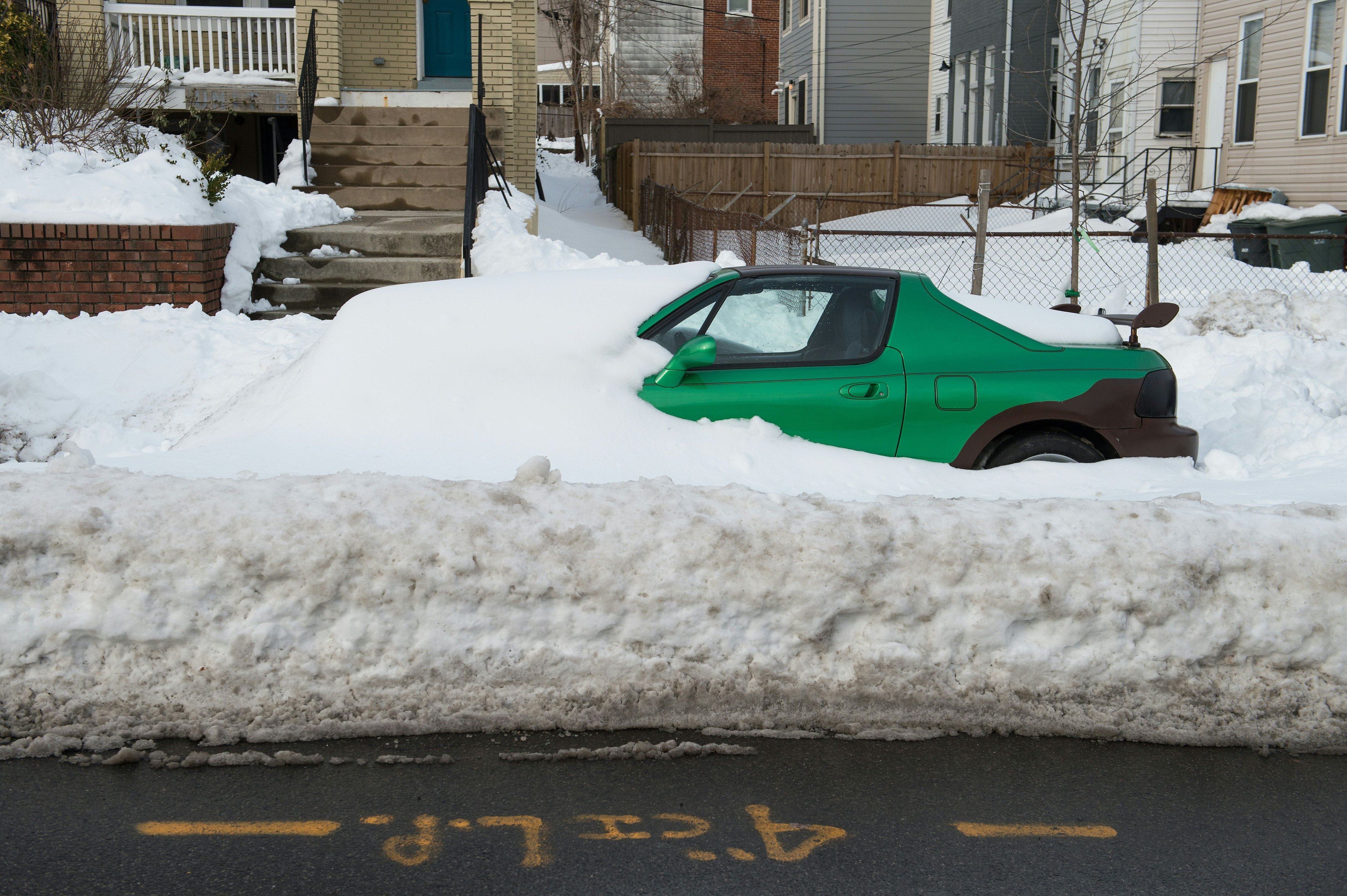 A car is stuck in snow along a street in Washington, DC, on Jan. 26. (Nicholas Kamm—AFP/Getty Images)