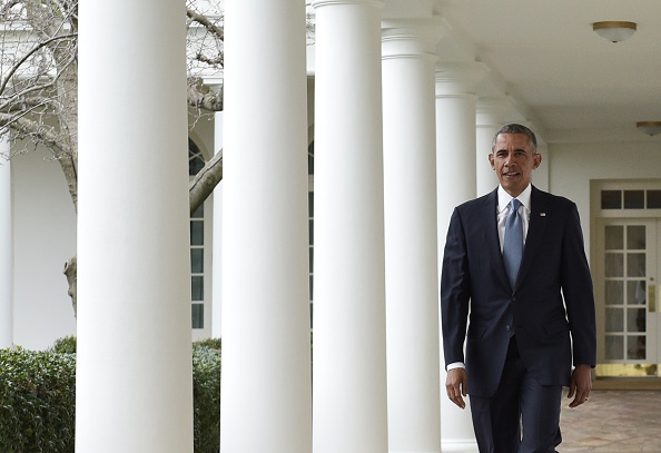 US President Barack Obama walks through the Colonnade from the Oval Office on January 12, 2016 in Washington, DC.