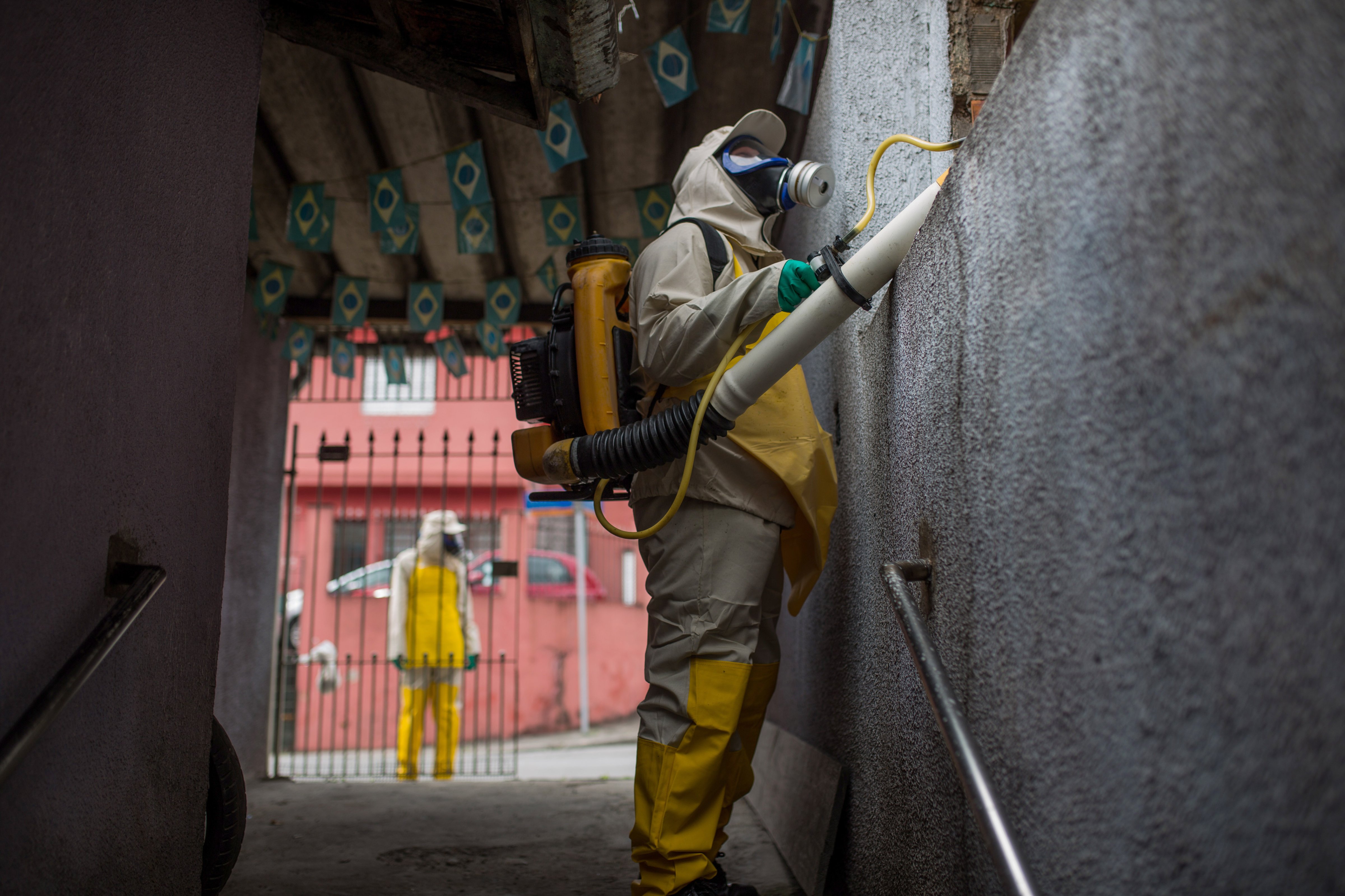 Agents working in pesticide fogging to combat mosquito larvae after the outbreak of the Zika virus on Jan. 29 in Sao Paulo, Brazil. (Victor Moriyama—Getty Images)