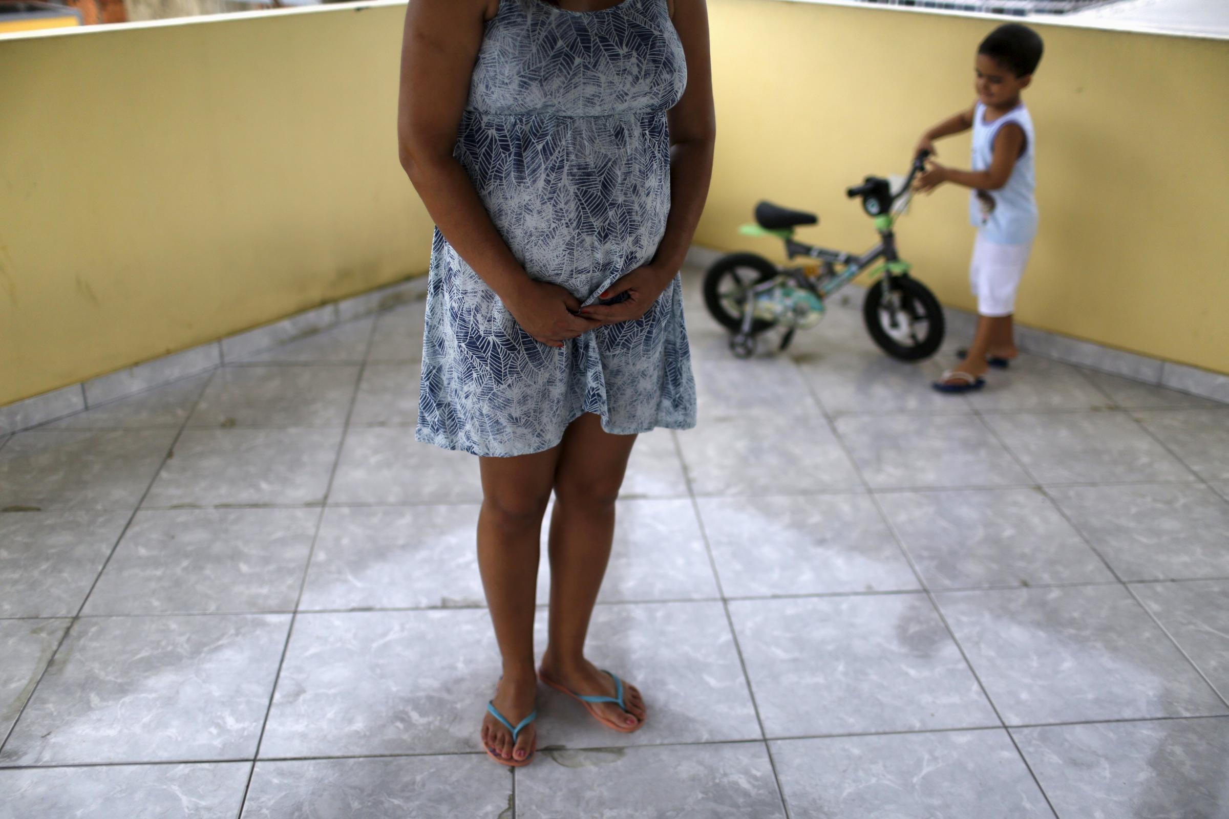 Gisele Felix, who is five months pregnant, stands on a terrace next to her son, Joao, at her home in Rio de Janeiro, Brazil, Jan. 28, 2016. Felix, who is concerned about the Zika virus, has not gone out of her house during her 30-day vacation, keeping all the windows and doors closed in an effort to keep out mosquitoes.