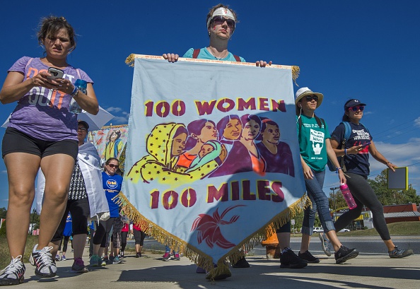 Participants in the "100 Women-100 Mile Pilgrimage" walk on a road after a lunch break on their trek, after stopping at the University Maryland Baltimore County on Sep. 20, 2015.