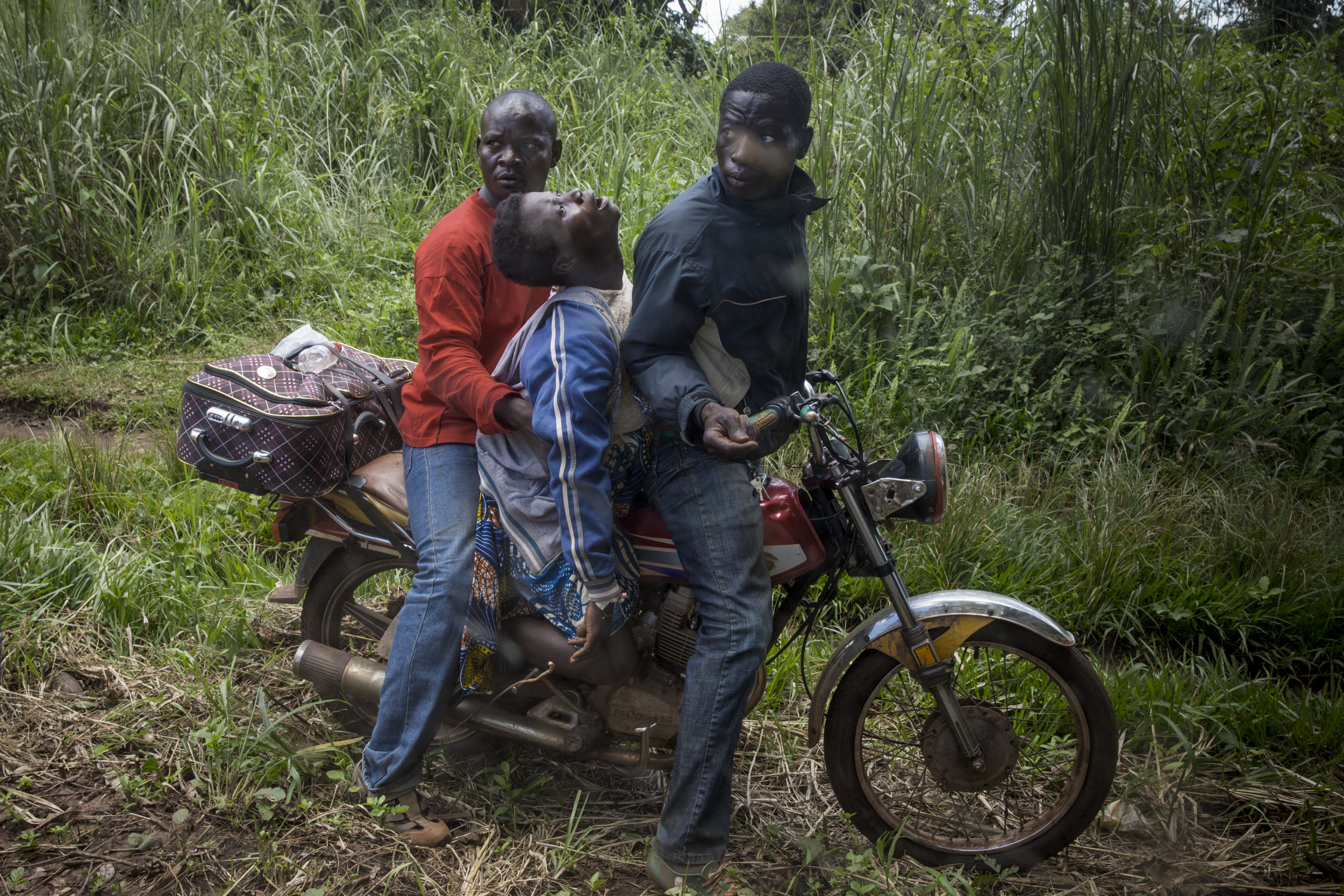 A woman suffering complications from pregnancy traveled for two hours on a motorbike from her village before a team from Doctors Without Borders took her to the hospital in Berberati, Central African Republic, Oct. 14, 2015.