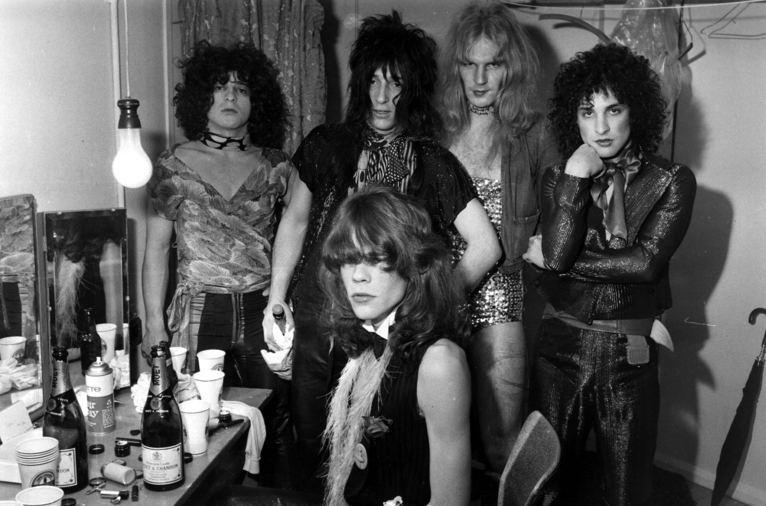 Influential American glam rock band the New York Dolls; David Johansen, front, Jerry Nolan, Johnny Thunders, Killer Kane and Sylvain Sylvain, pose in a dressing room. 1972.