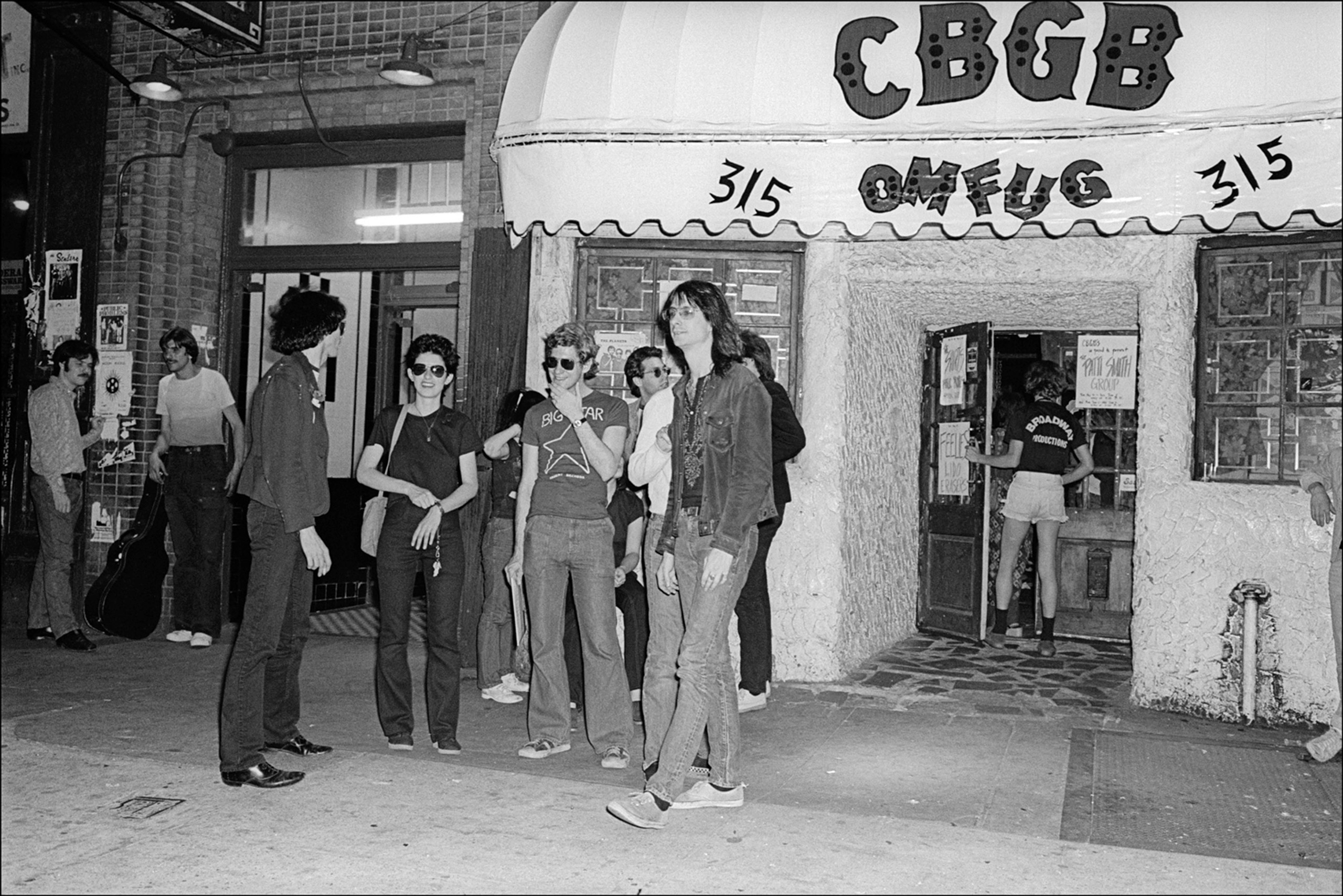 Lenny Kaye, of the Patti Smith Group, takes a break outside CBGB on the Bowery, New York, N.Y., May 28, 1977.