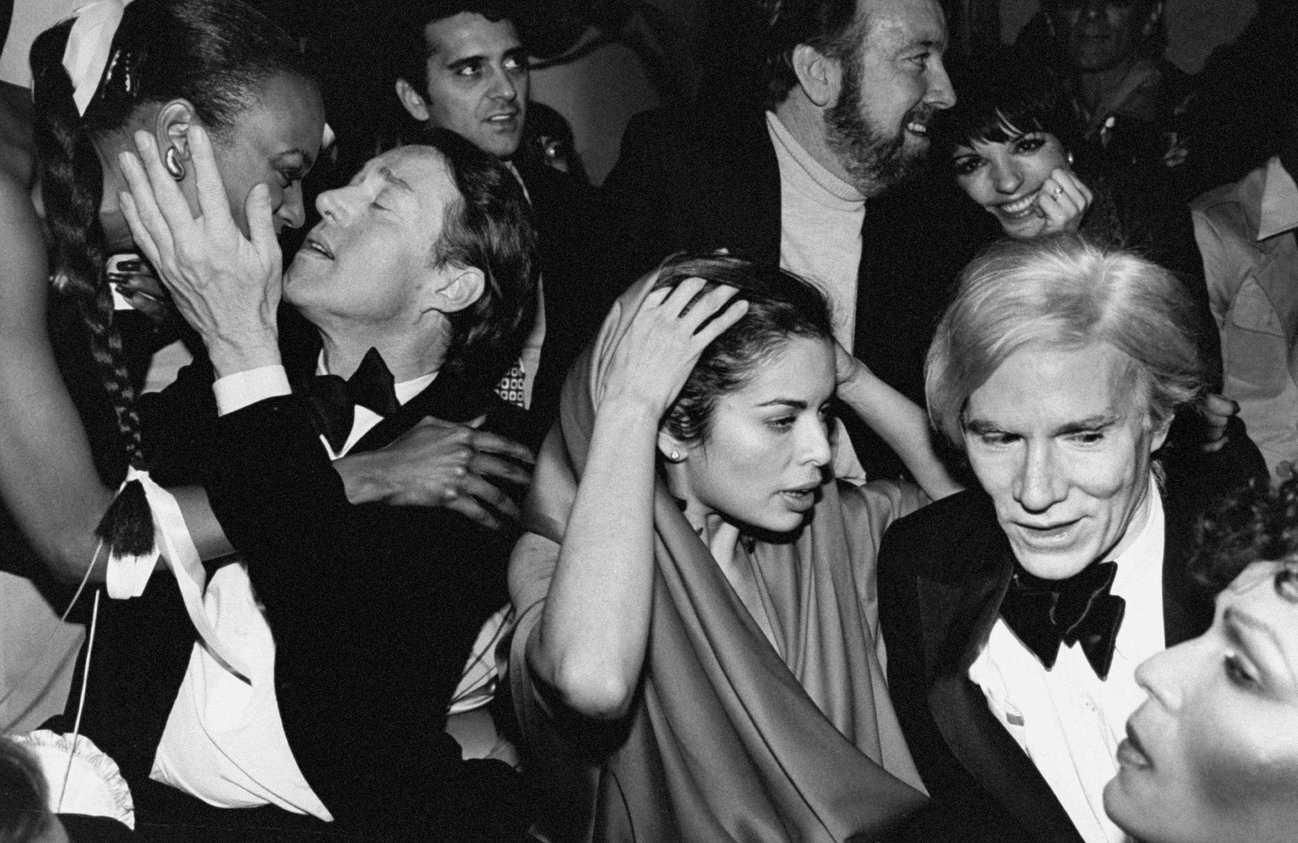Celebrities during New Year's Eve party at Studio 54: Halston, Bianca Jagger, Jack Haley, Jr. and wife Liza Minnelli and Andy Warhol.  1978.