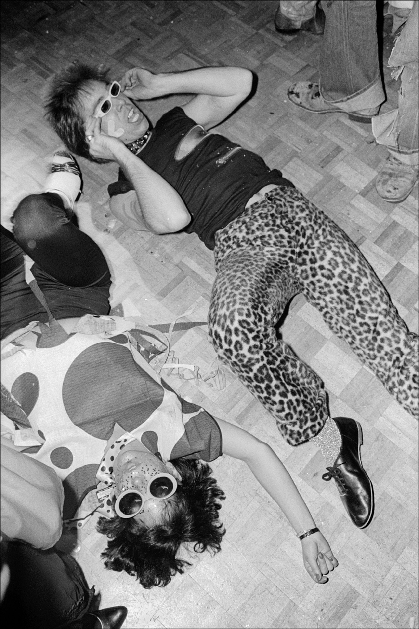 A pair of clubgoers dressed as punks lie on the floor at Studio 54's third annual Halloween party, New York, N.Y., Oct. 31, 1978.
