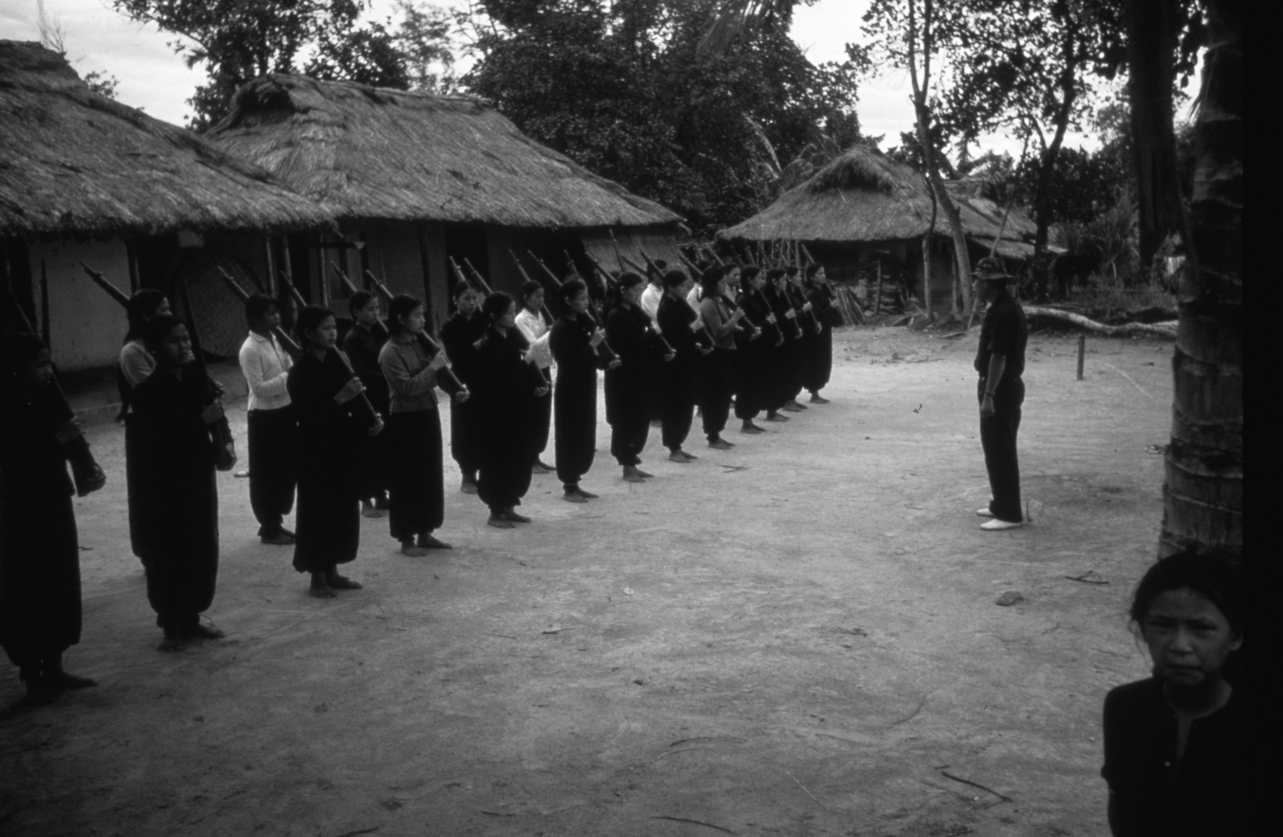 A group of Vietnamese women train with rifles in a village near the Laotian border, ca. 1962.