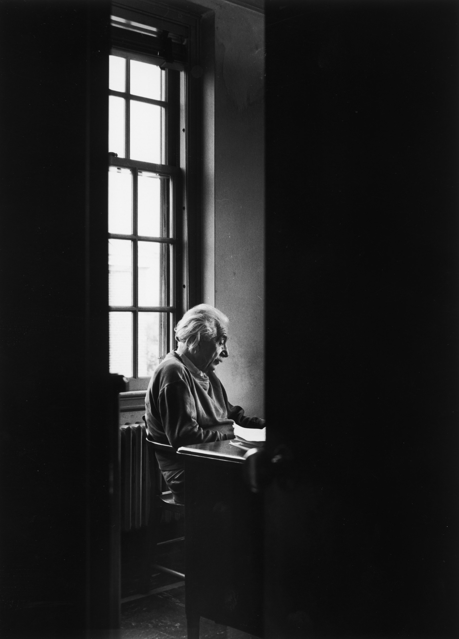 Albert Einstein sitting alone at the Institute for Advanced Study, 1947.