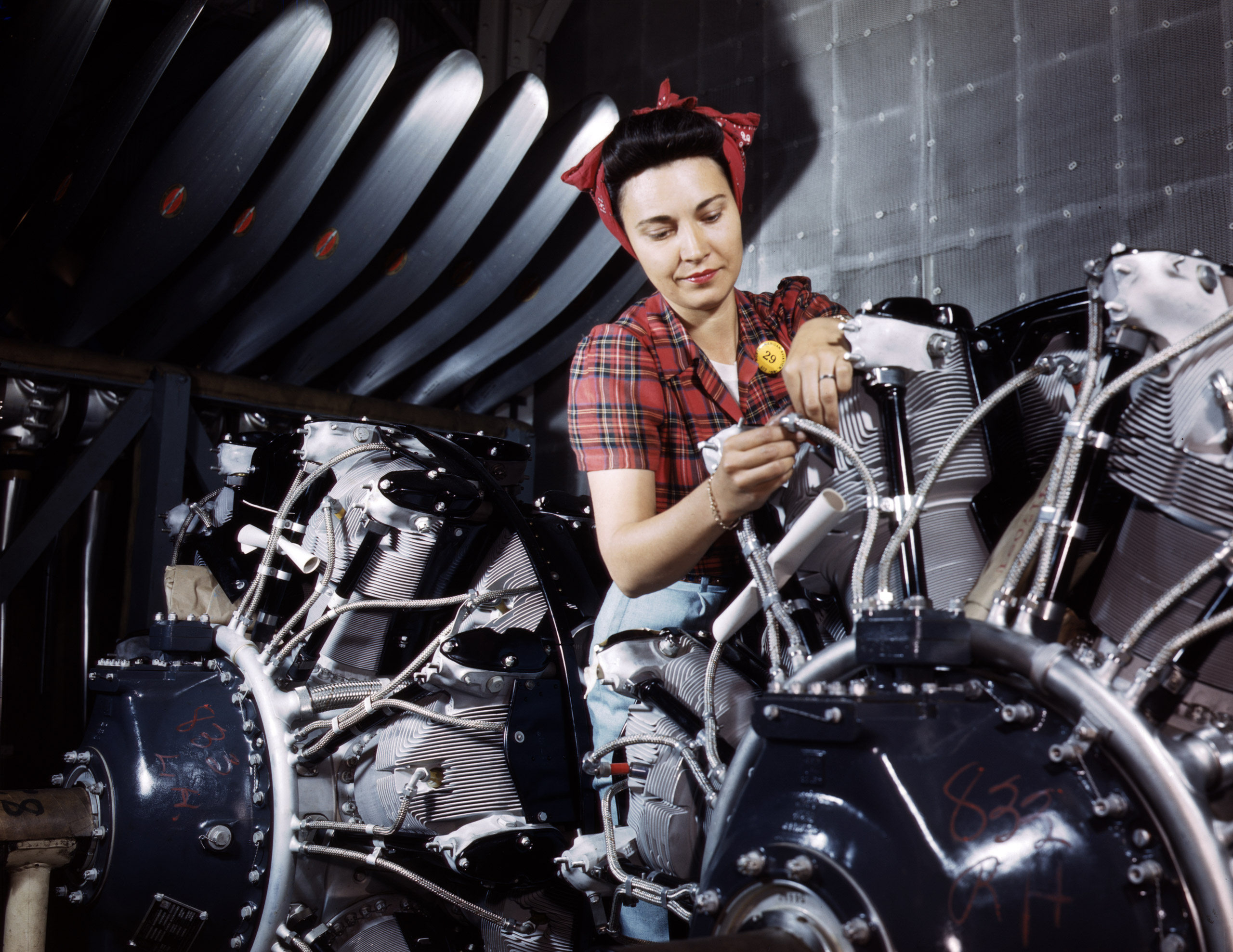 Woman working on an airplane motor at North American Aviation, Inc., plant in California, June 1942. Photographed by Alfred T. Palmer for the Farm Security Administration.