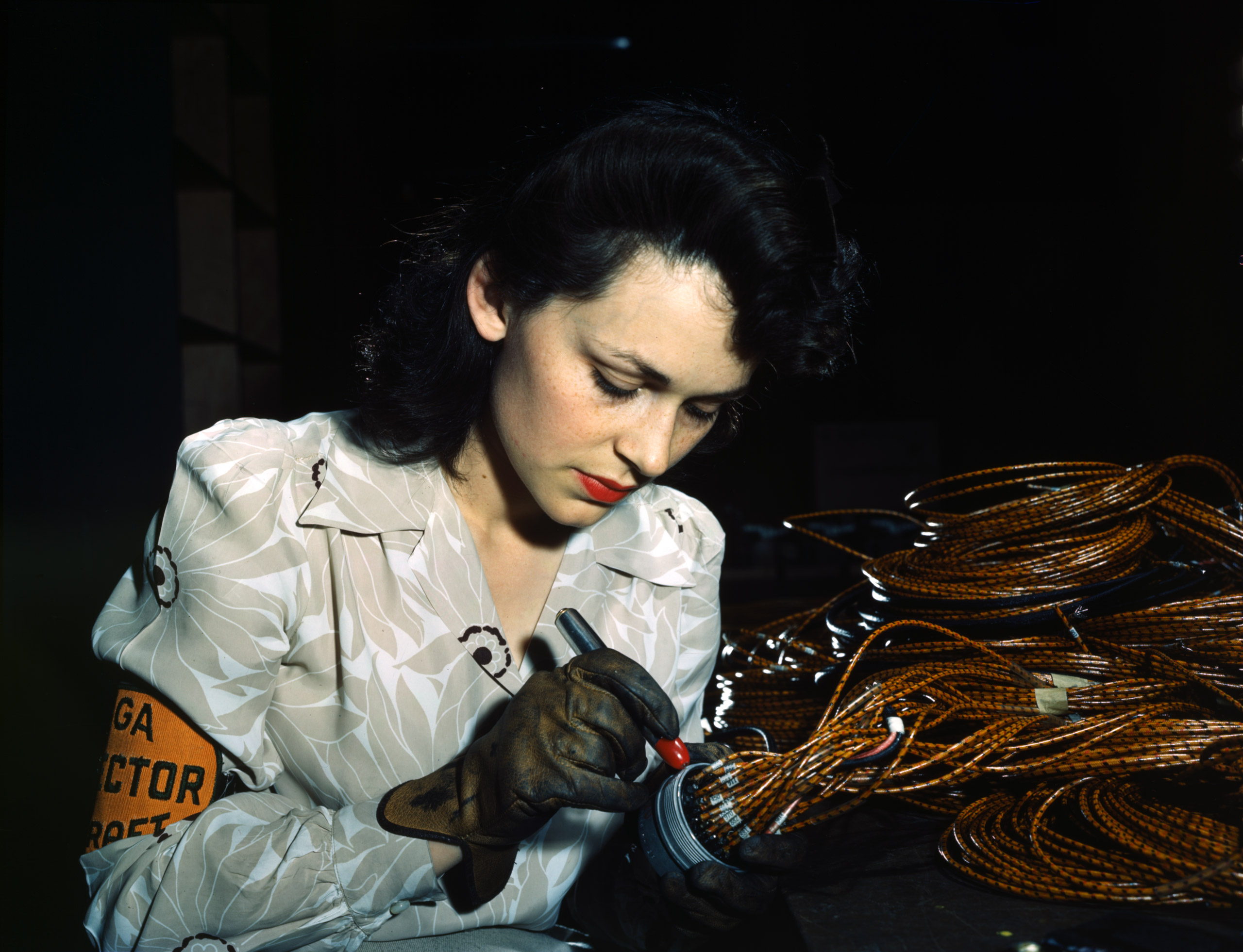Woman aircraft worker, Vega Aircraft Corporation, Burbank, Calif. Shown checking electrical assemblies, June 1942. Photographed by David Bransby for the Farm Security Administration.