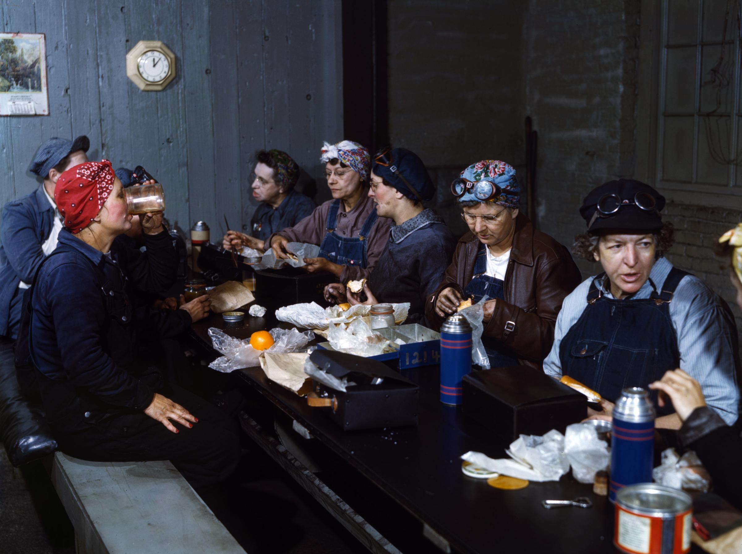 Women workers employed as wipers in the roundhouse having lunch in their rest room, Chicago and North Western Railway Company, Clinton, Iowa, April 1943. Photographed by Jack Delano for the Farm Security Administration.