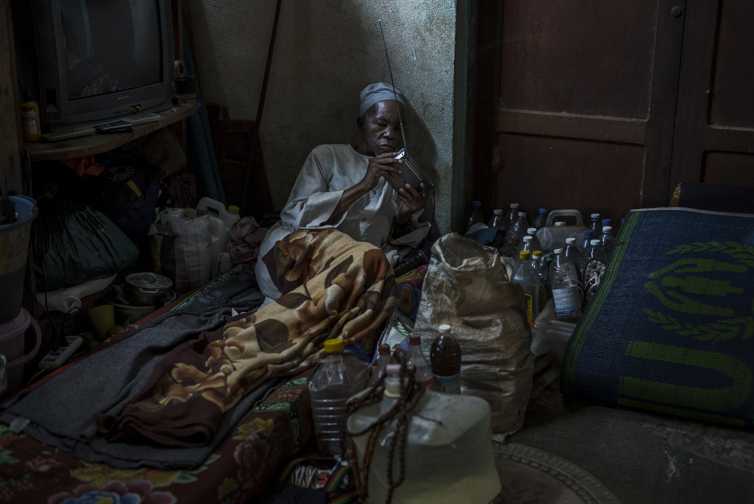 A man listens to his radio in a building situated in the compound of the church of Carnot, Central African Republic, Oct. 18, 2015. About 500 muslims have been living there for 22 months with little access to food and health care.