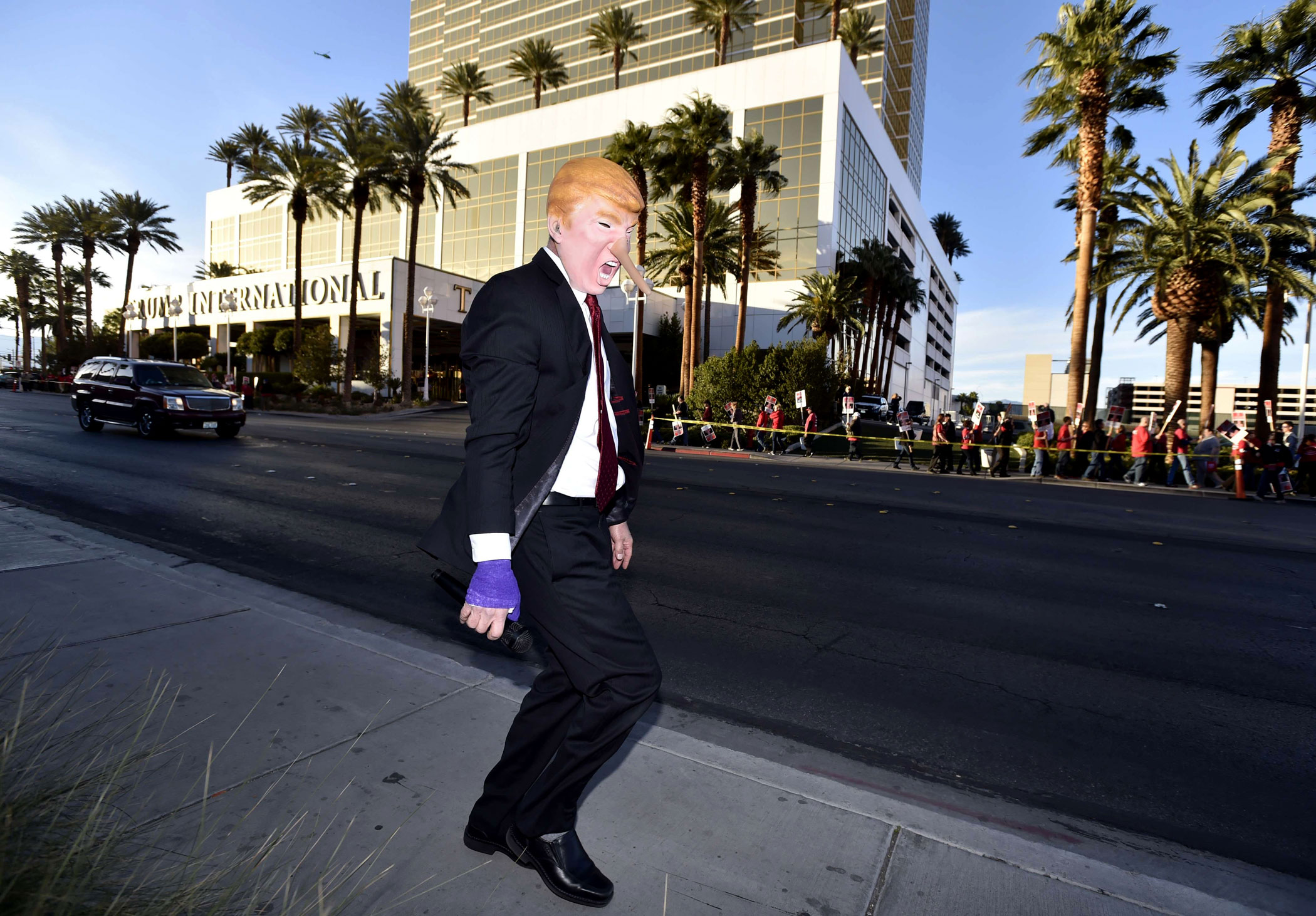 Gil Mobley wears a costume in the likeness of Donald Trump in front of the Trump Hotel in Las Vegas on Feb. 23, 2016.