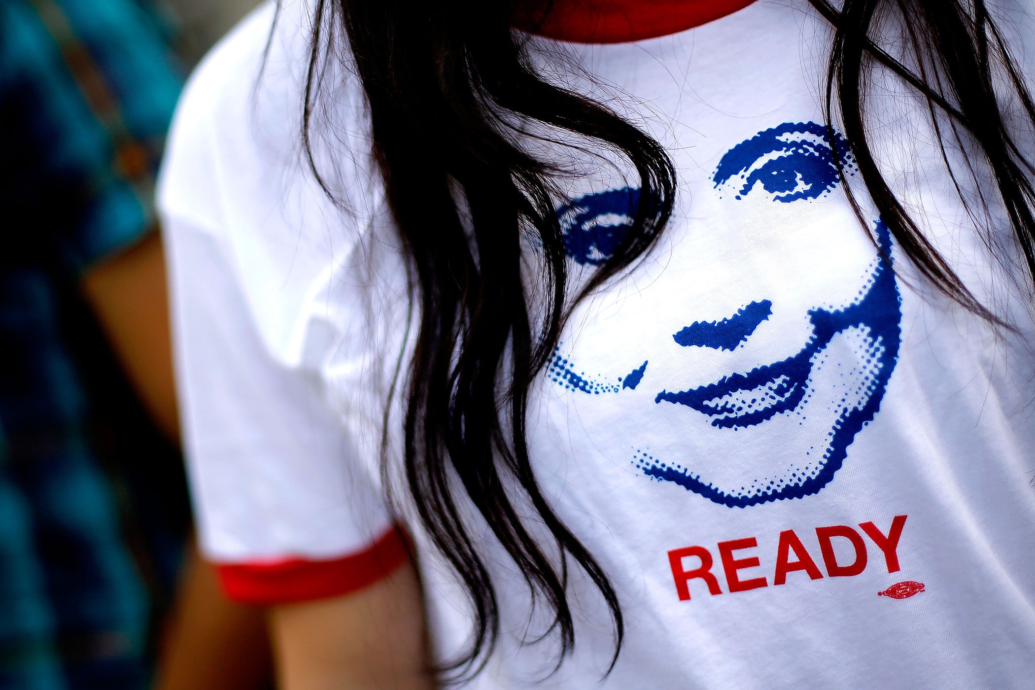 A supporter of former U.S. Secretary of State Hillary Clinton wears a T-shirt with an image depicting her as people arrive to hear her speak about her new book "Hard Choices" in Washington