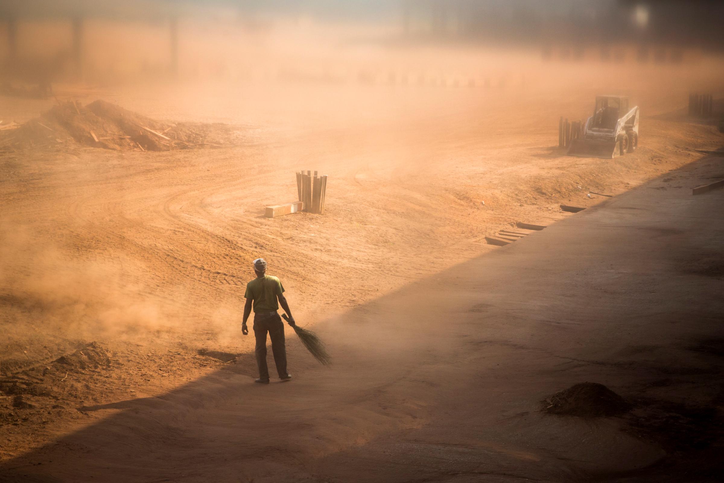 A worker sweeps wood dust at a timber factory near Mambelé, Central African Republic, Dec. 11, 2015. According to a report released by Global Witness last July, foreign logging companies paid millions of euros to Muslim rebels known as Séléka and mostly Christian militias known as antibalaka. Logging companies claim they are forced, like any other companies in the country, to pay bribes for security against attacks. The sector employed approximately 4,000 people—and apparently supported 6,000 indirect jobs, a figure that is now in decline, according to the Minister of Forests.