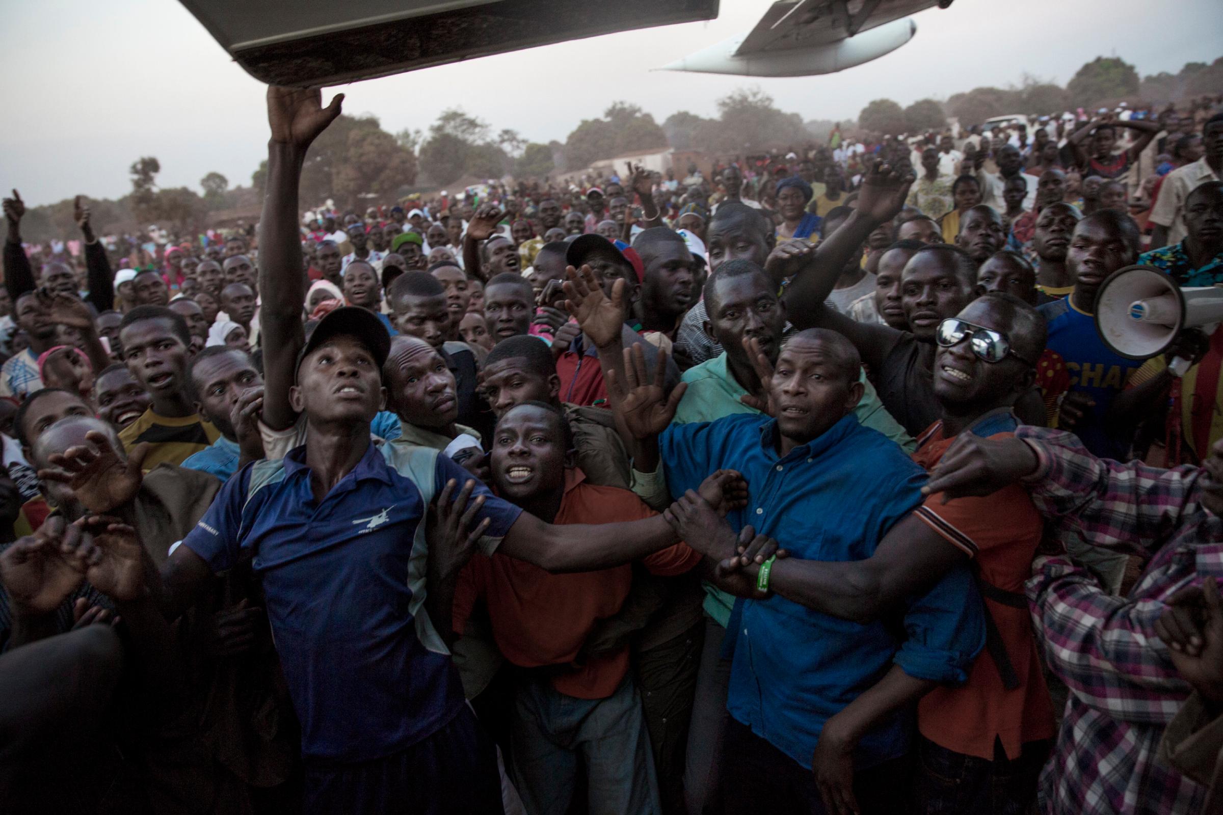 Supporters of Muslim presidential candidate Karim Meckassoua are held back at an airport in Bria, eastern Central African Republic, Dec. 24, 2015. Thousands of supporters, some asking for money, came to welcome him.