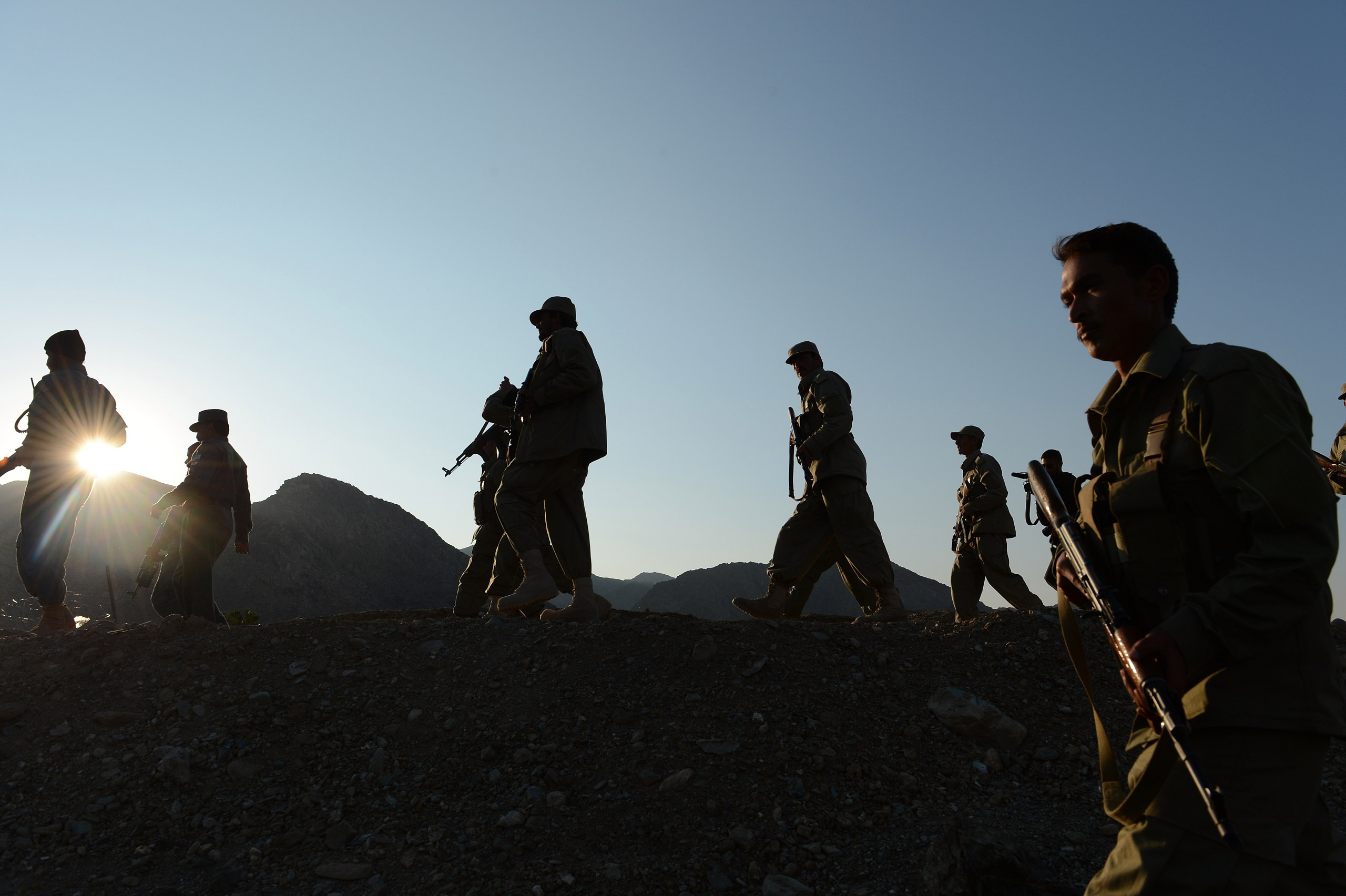 Afghan Local Police (ALP) personnel patrol near their base in Goshta district of Nangarhar province, on Dec. 18, 2012. (Shah Marai—AFP/Getty Images)