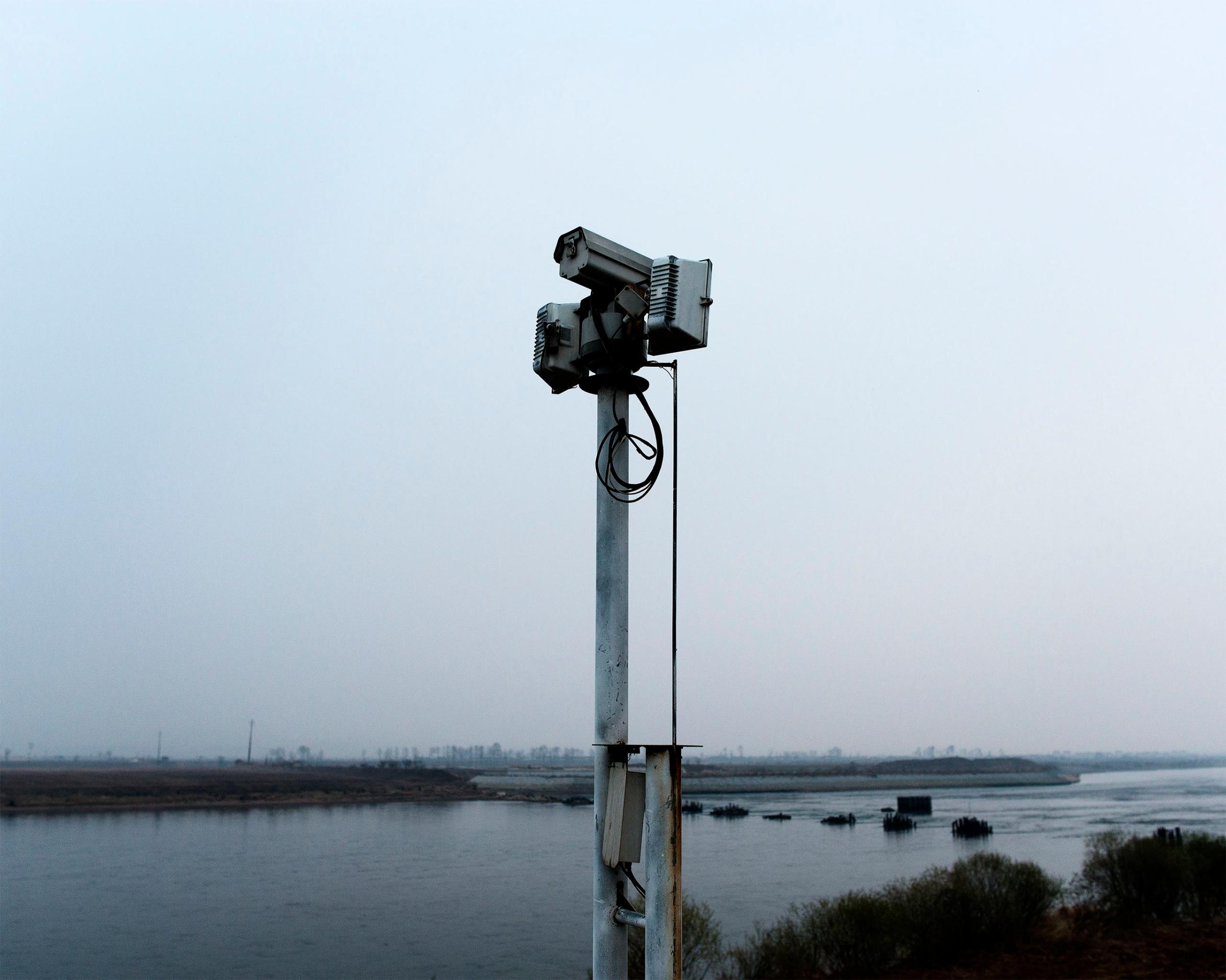Security cameras in Dandong, China keep watch over a narrow stretch of the Yalu River that is sometimes crossed by North Korean defectors.
