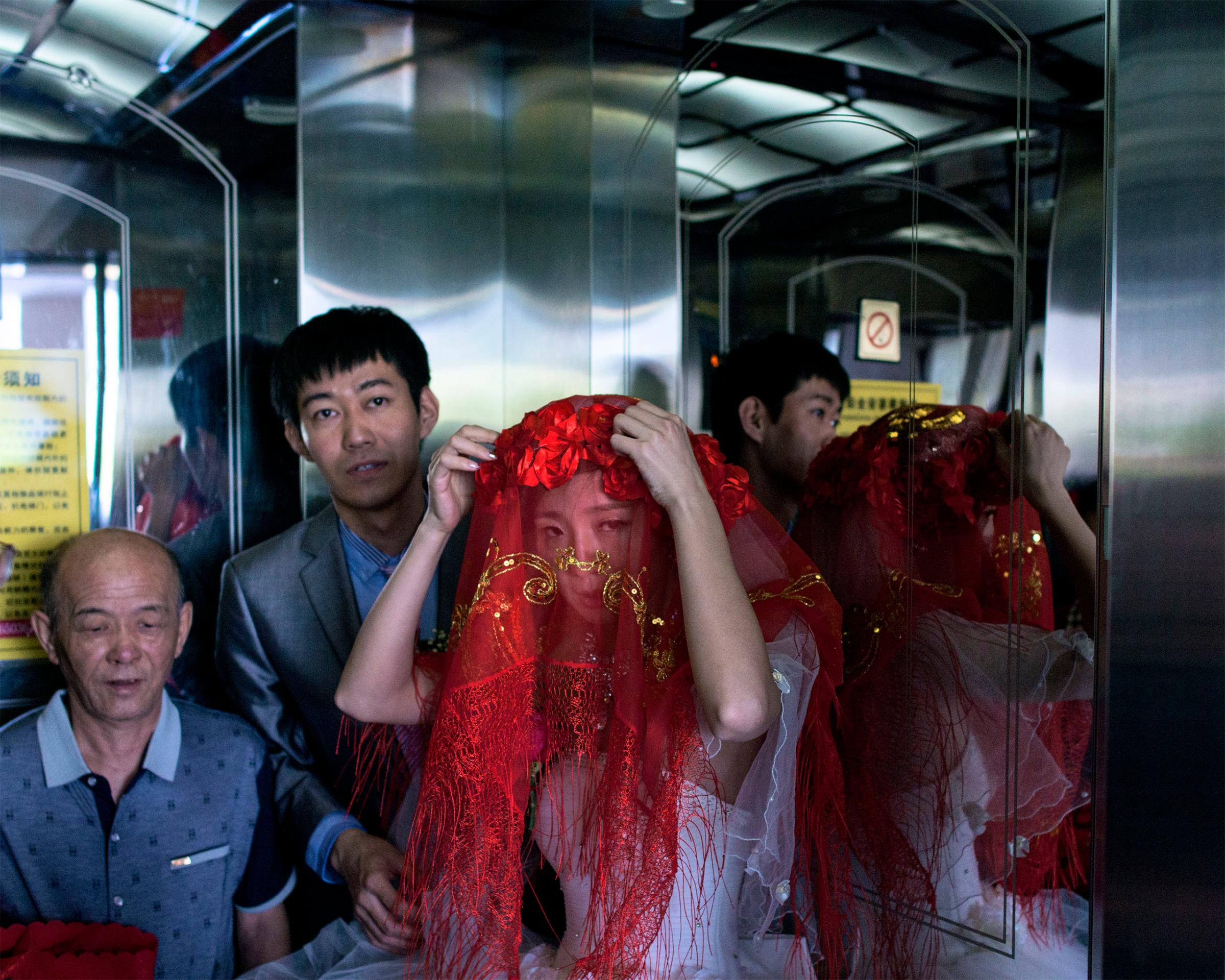 A bride adjusts her veil near Jian, China, about 1 km away from the North Korean border.