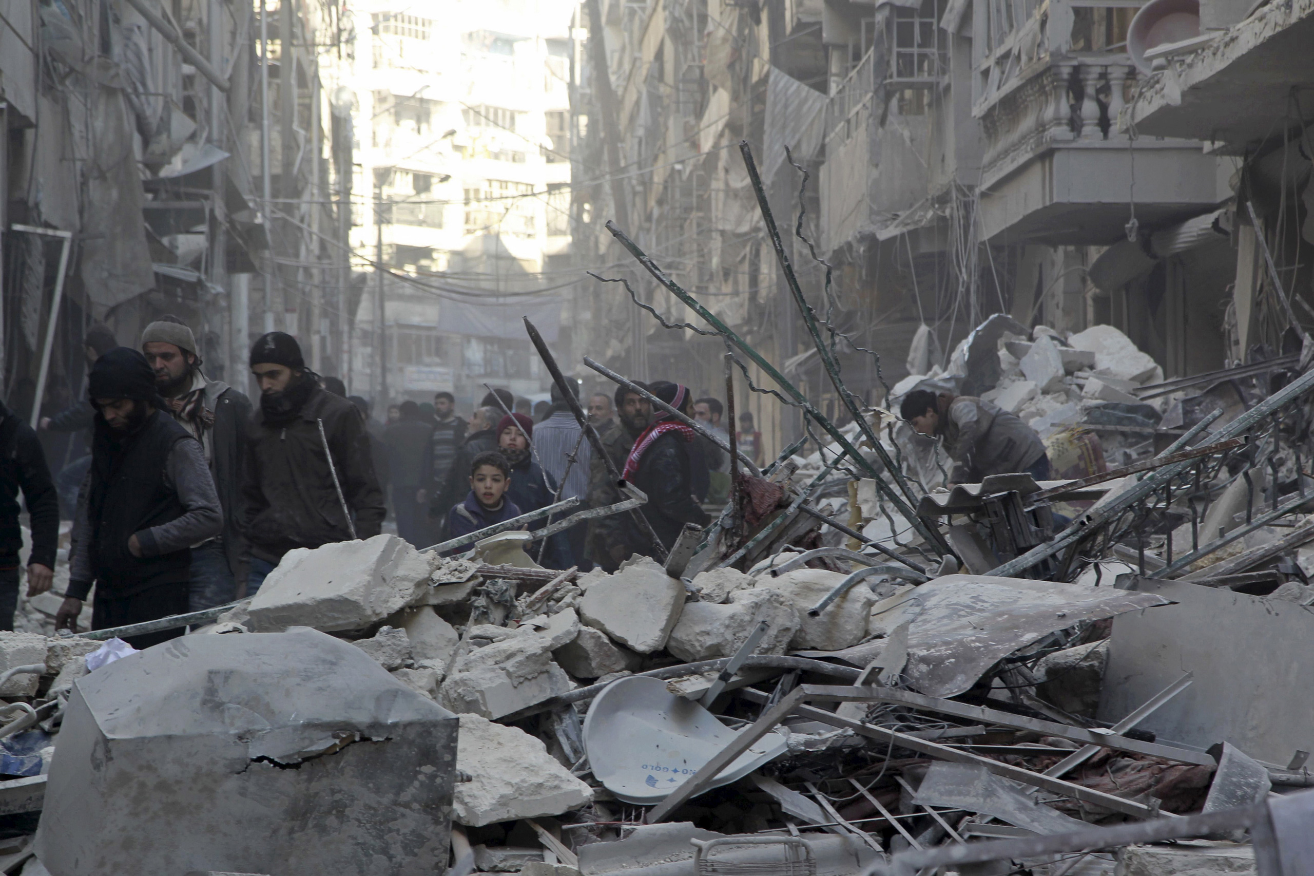Residents inspect damage after airstrikes by pro-Syrian government forces in the rebel held Al-Shaar neighborhood of Aleppo, Syria, on Feb. 4, 2016. (Abdalrhman Ismail—Reuters)