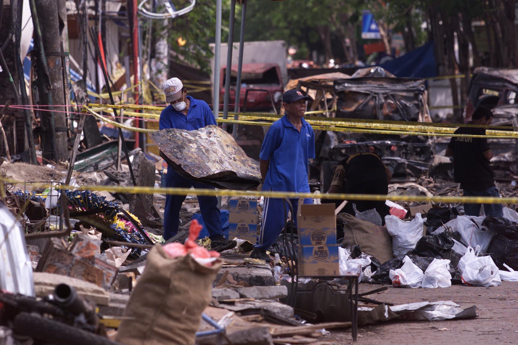 File photo dated Oct. 16, 2012, of investigators removing debris from the Sari Club in Kuta, Bali, bombed by the extremist group Jemaah Islamiyah (Chris Ison—AP Wire/Press Association Images)