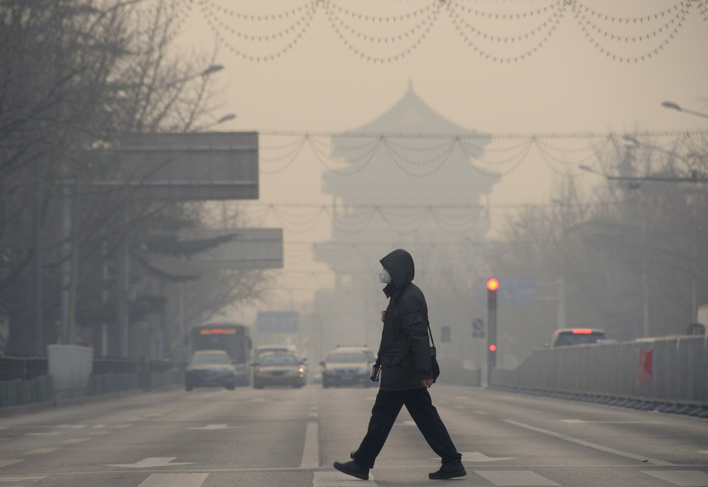 BEIJING, Dec. 29, 2015-- A pedestrian walks amid heavy smog in Beijing, capital of China, Dec. 29, 2015. A blue alert for heavy air pollution was issued by Beijing municipal emergency response headquarters. Beijing has been bothered by heavy pollution since the winter came. (Xinhua/Wu Wei)